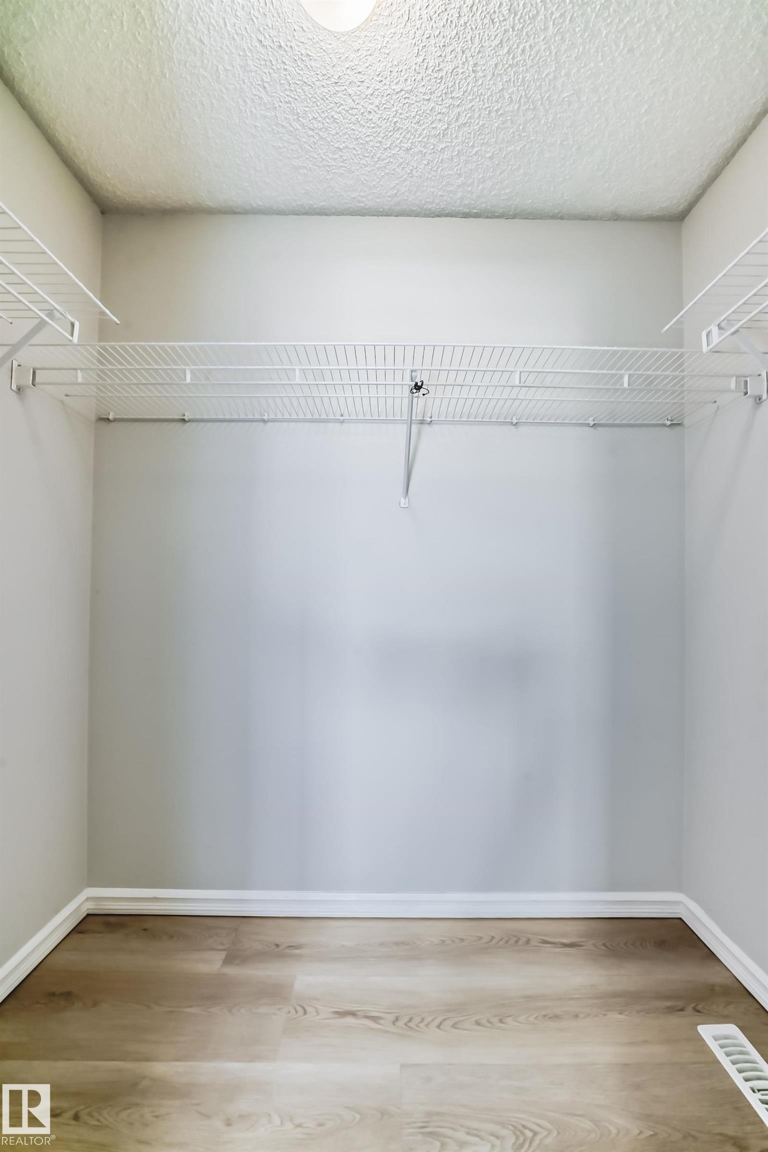 Spacious closet featuring light wood-style floors - 7731 8 Avenue, Edmonton, AB - Indoor With Storage