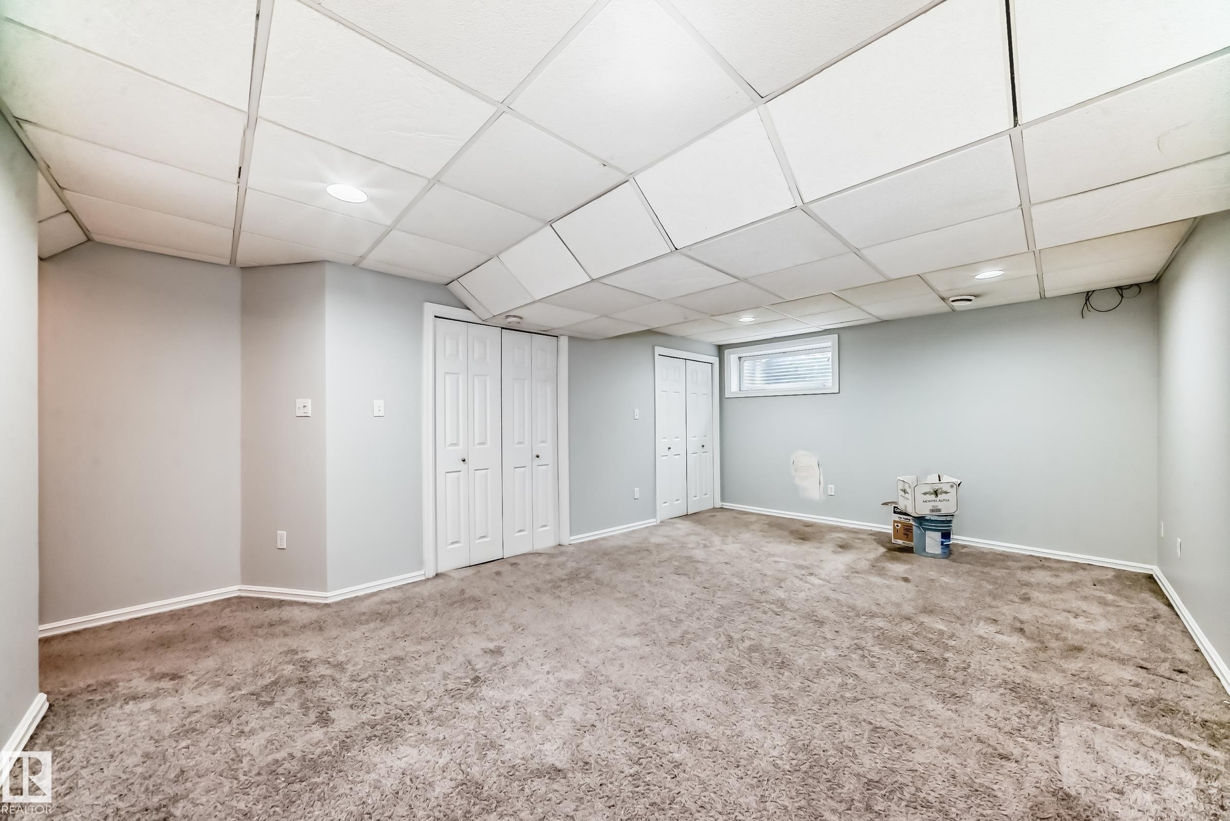 Finished basement featuring a drop ceiling, carpet floors, and recessed lighting - 7731 8 Avenue, Edmonton, AB - Indoor