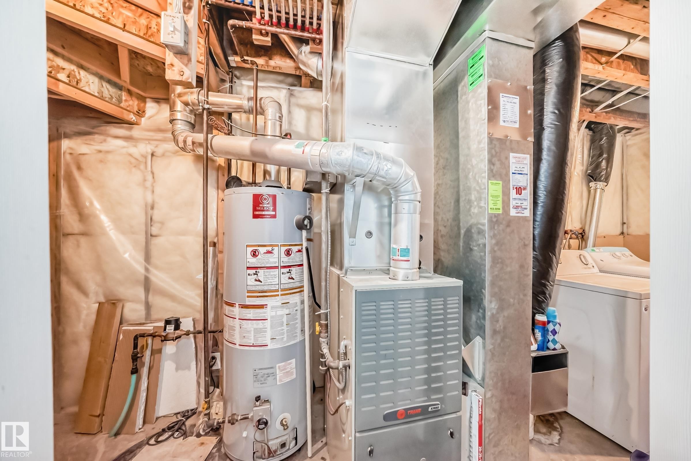 Utilities featuring washer / dryer, water heater, and heating unit - 7731 8 Avenue, Edmonton, AB - Indoor Photo Showing Basement