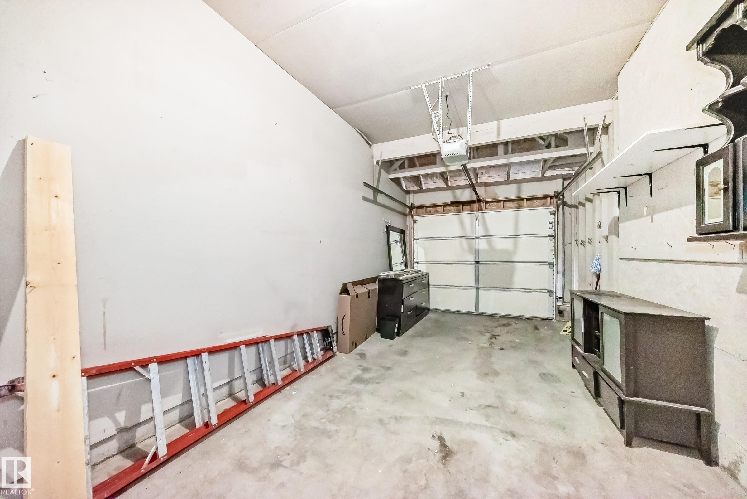 Garage featuring a garage door opener - 7731 8 Avenue, Edmonton, AB - Indoor Photo Showing Garage