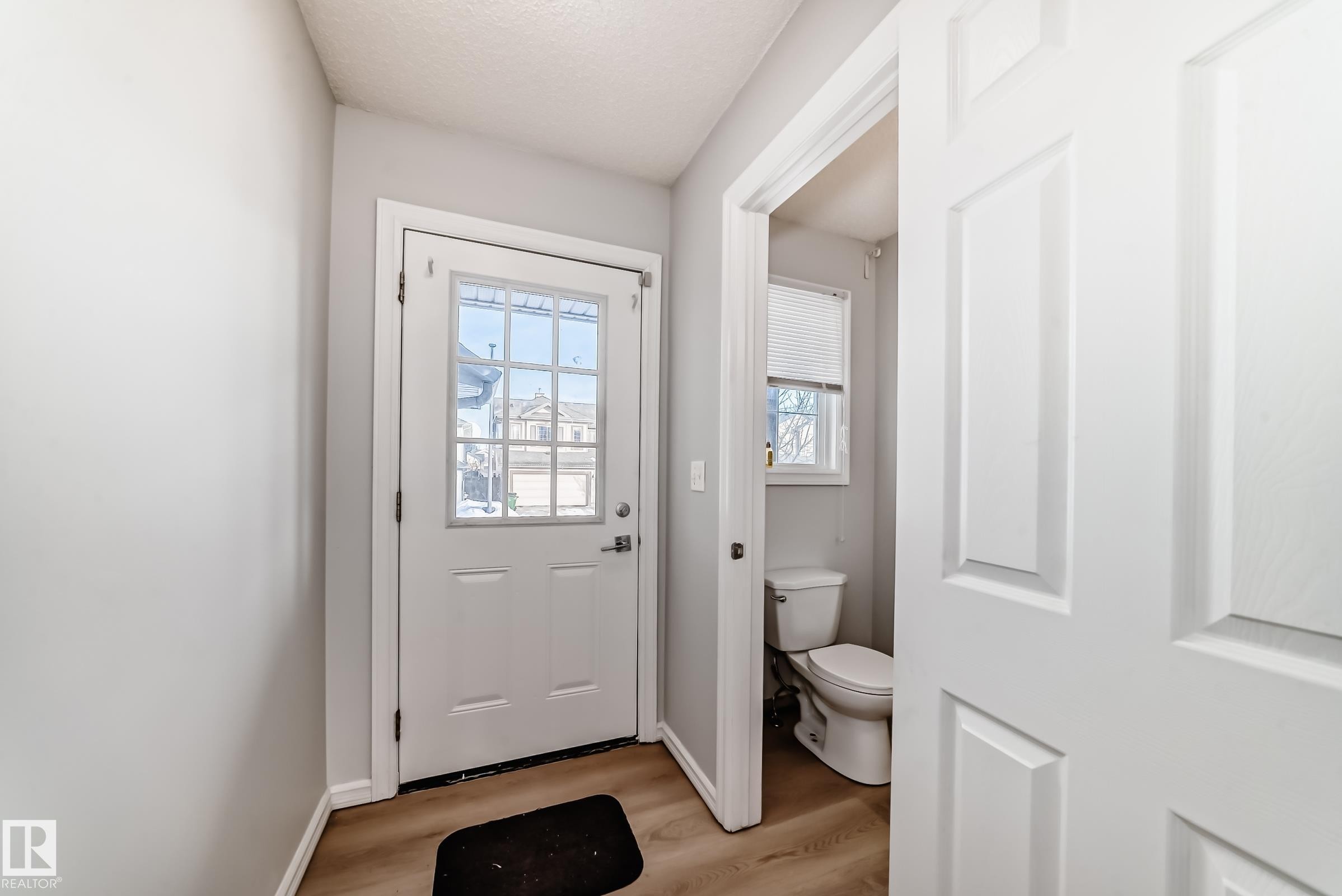 Doorway to outside featuring wood finished floors - 7731 8 Avenue, Edmonton, AB - Indoor Photo Showing Other Room