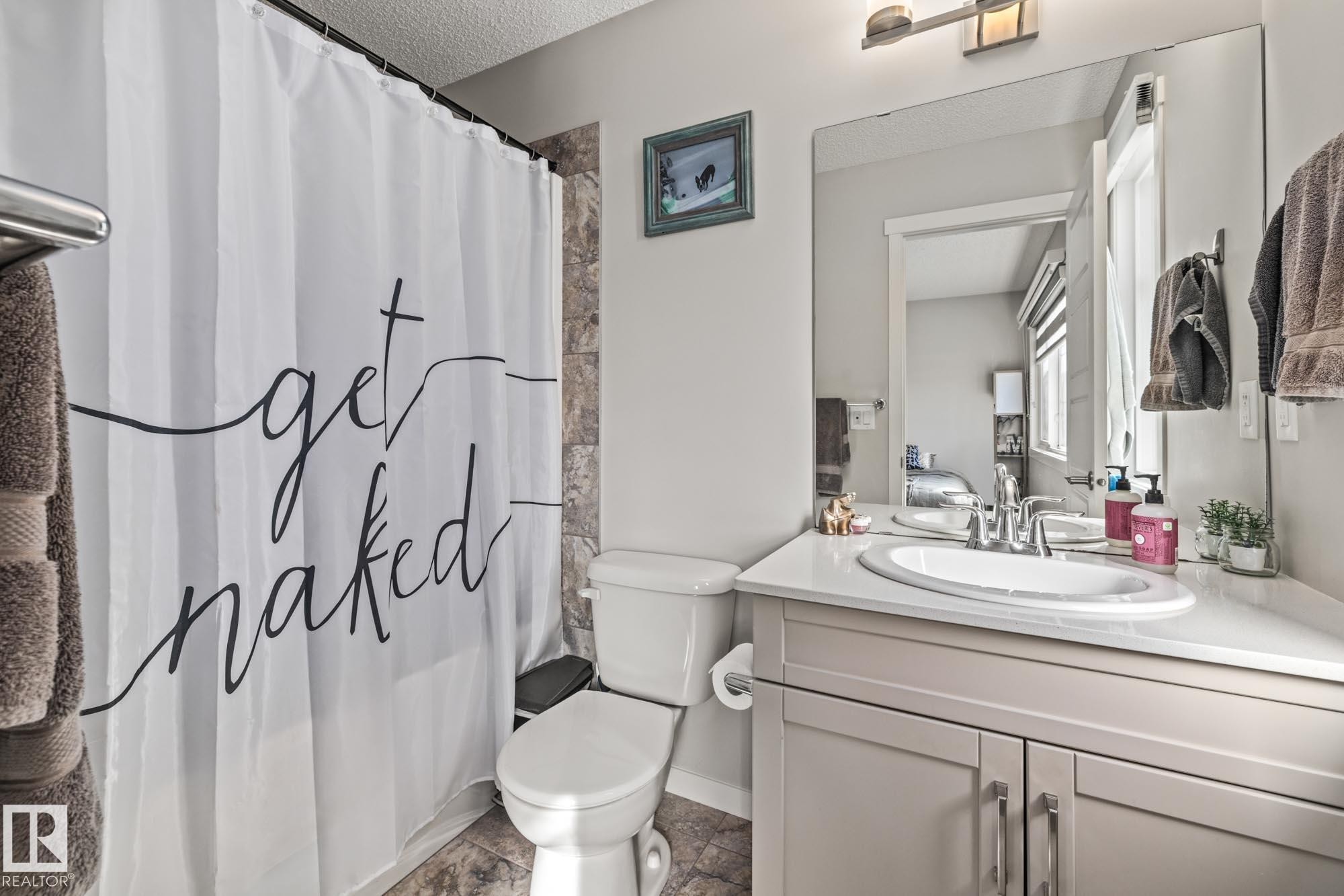 Bathroom with vanity and a textured ceiling - 20110 27 Avenue, Edmonton, AB - Indoor Photo Showing Bathroom