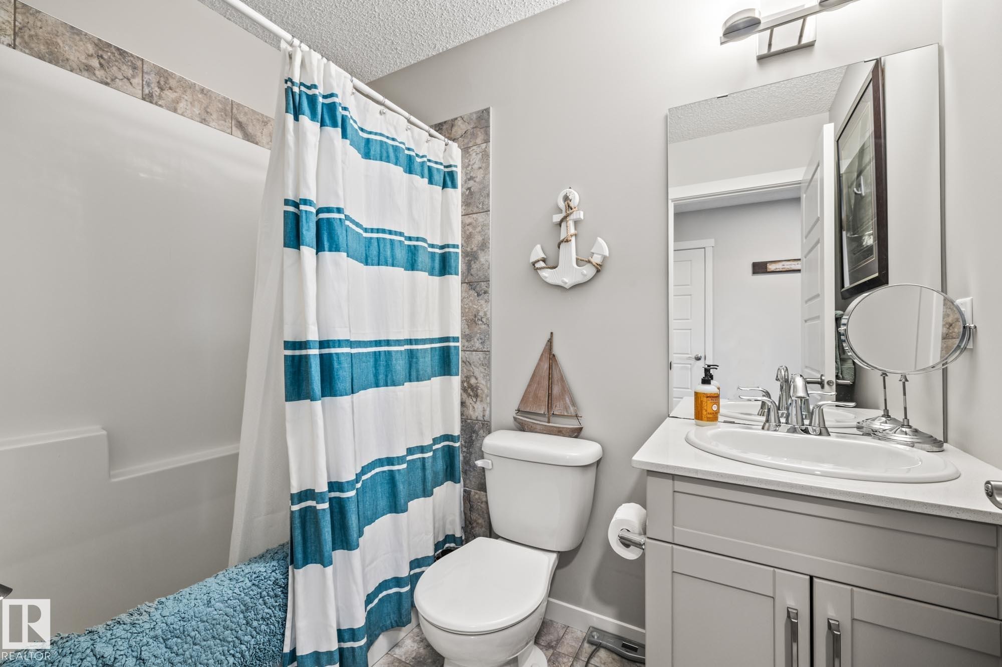 Bathroom featuring a textured ceiling and vanity - 20110 27 Avenue, Edmonton, AB - Indoor Photo Showing Bathroom