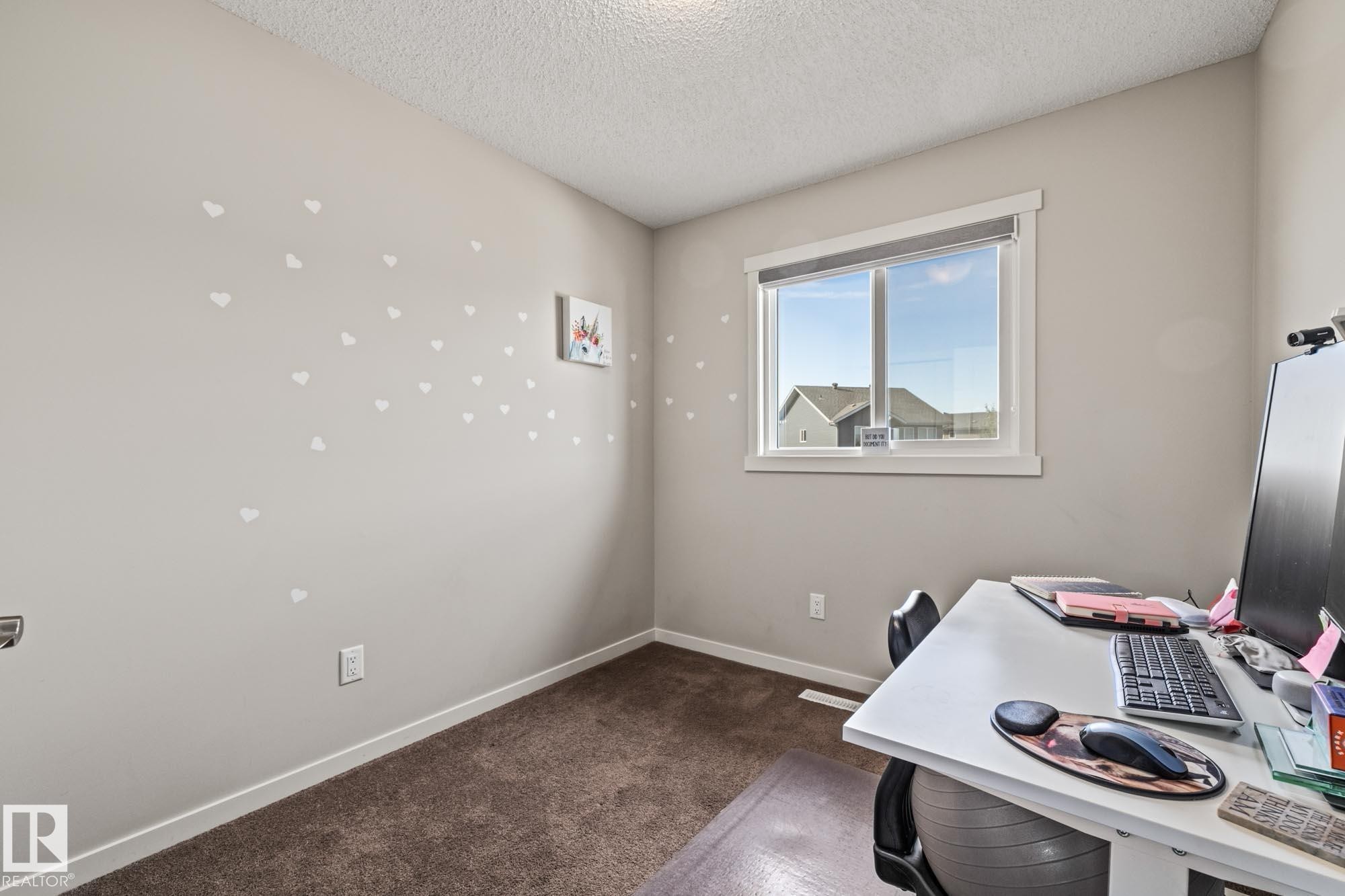 Bedroom featuring a textured ceiling and dark carpet - 20110 27 Avenue, Edmonton, AB - Indoor