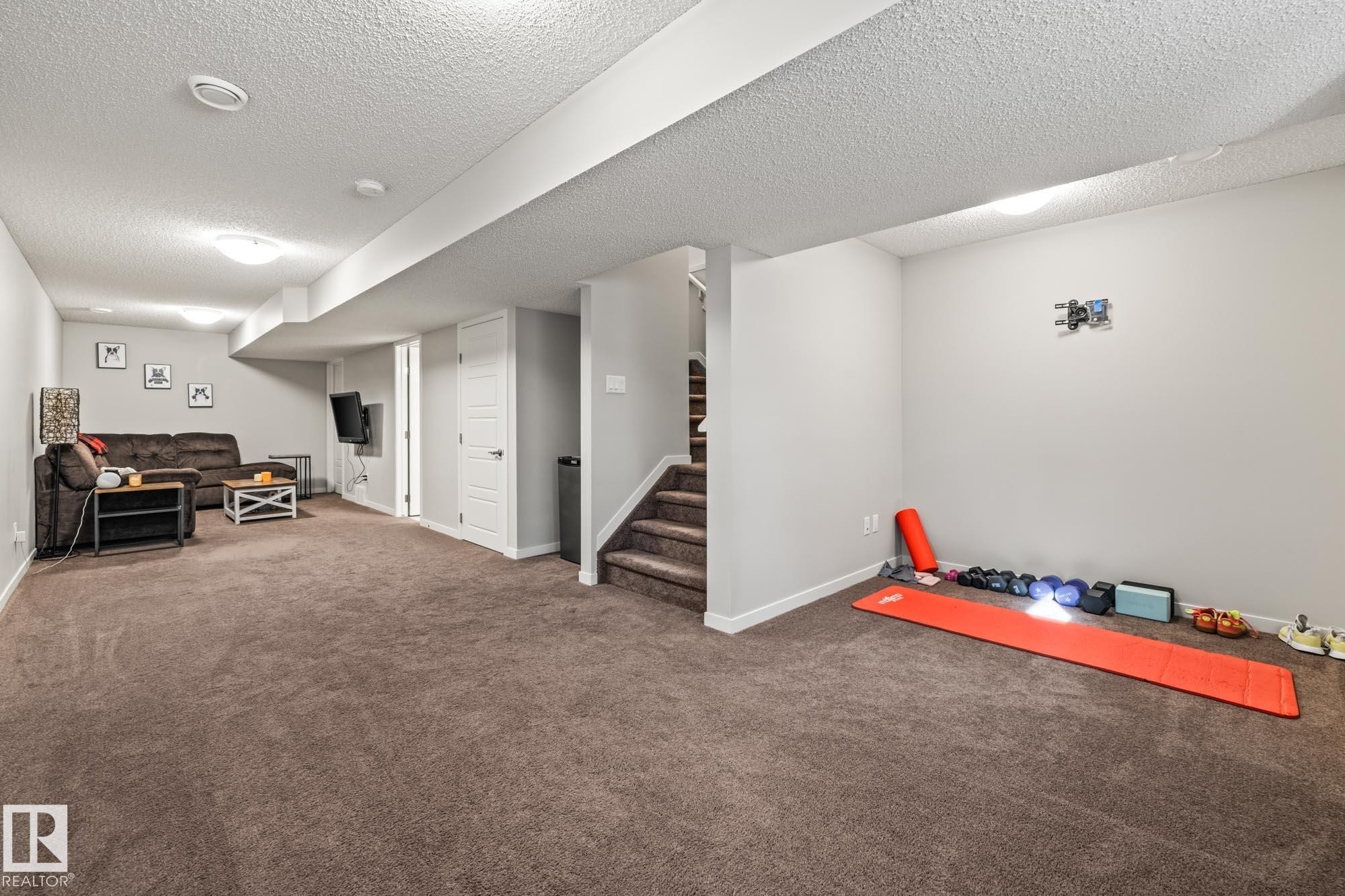 Exercise area with carpet floors and a textured ceiling - 20110 27 Avenue, Edmonton, AB - Indoor Photo Showing Other Room