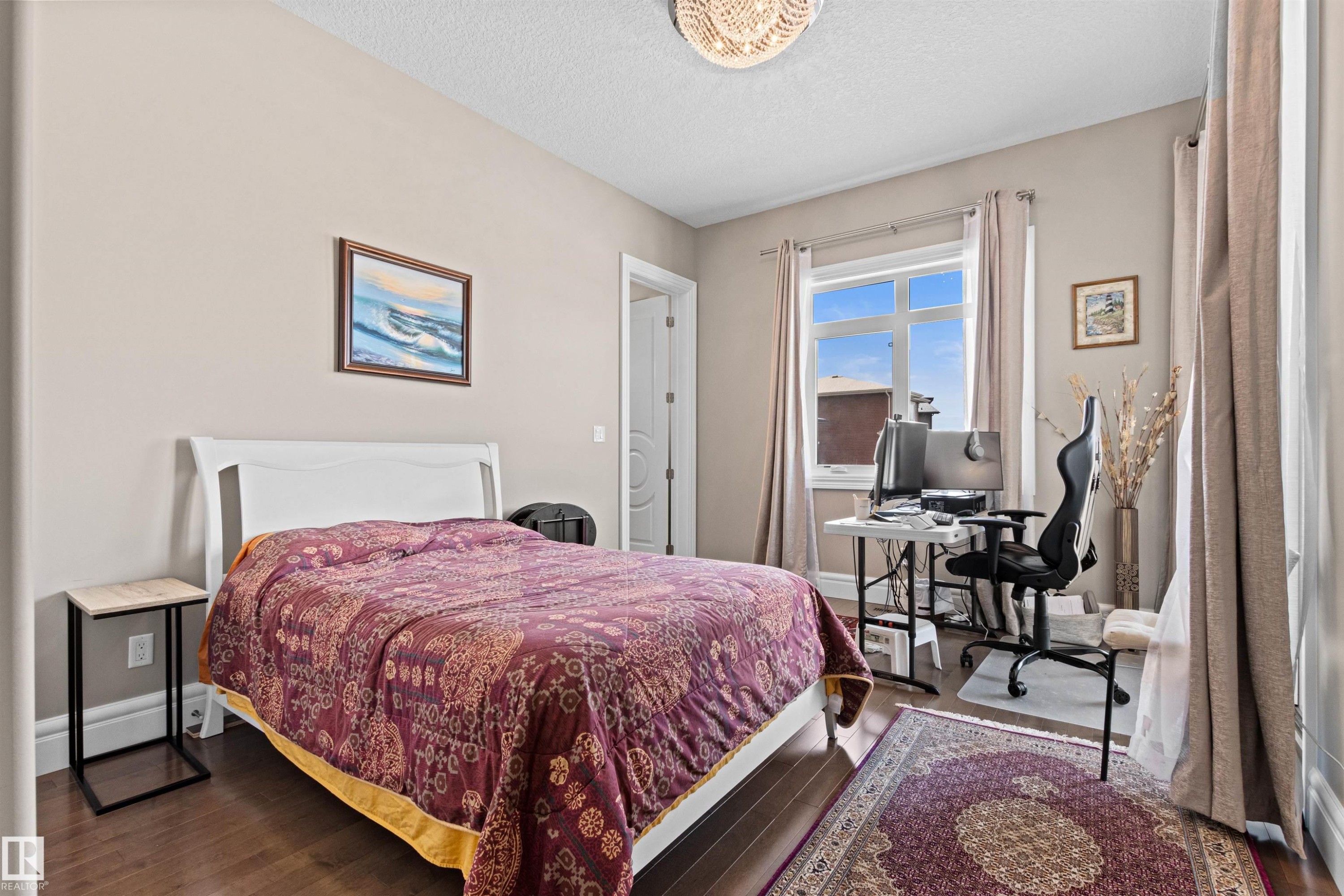 Bedroom with a desk, wood finished floors, and a textured ceiling - 2796 Wheaton Drive, Edmonton, AB - Indoor Photo Showing Bedroom