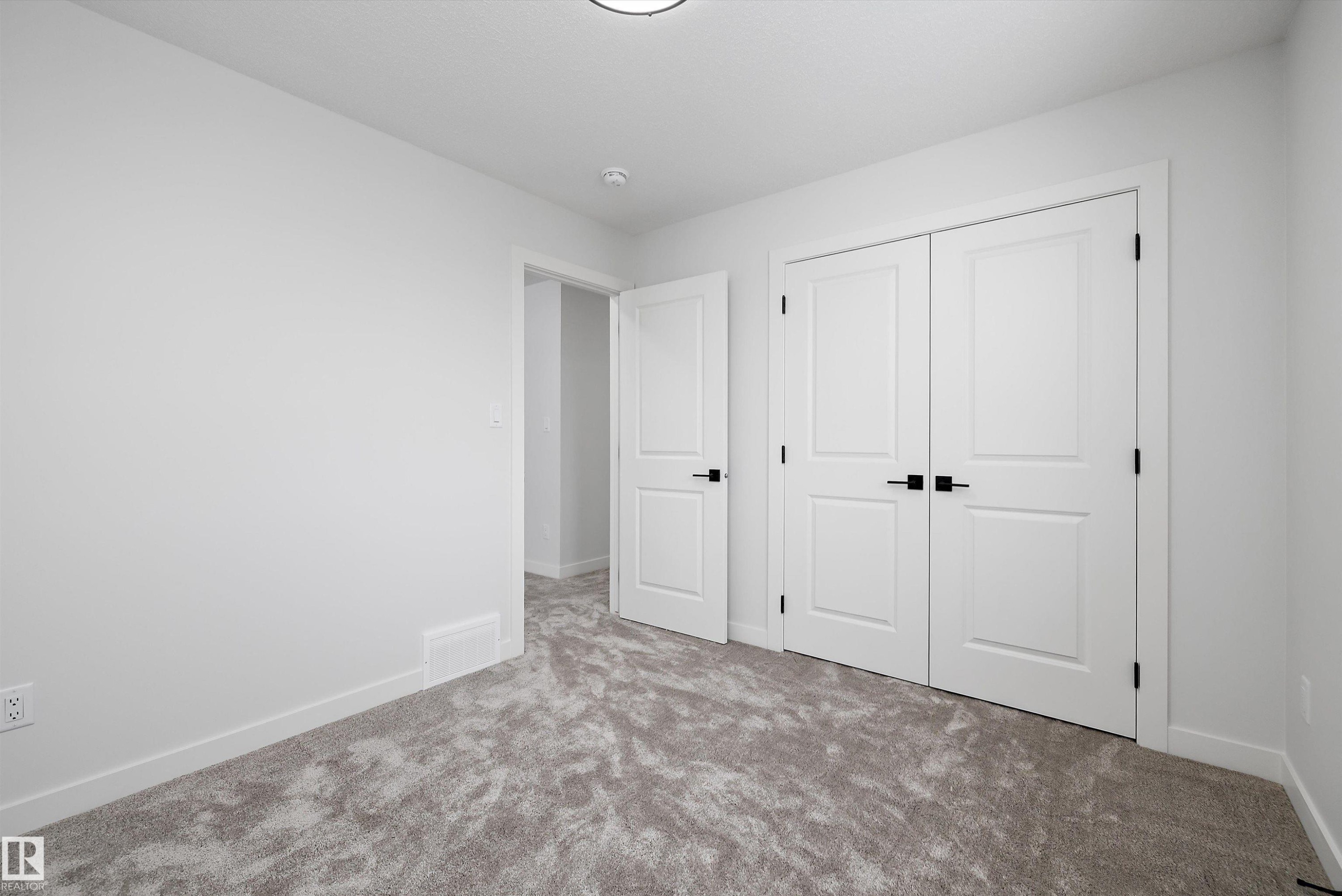 Unfurnished bedroom featuring carpet and a closet - 230 Edgemont Green Green Nw, Edmonton, AB - Indoor Photo Showing Other Room