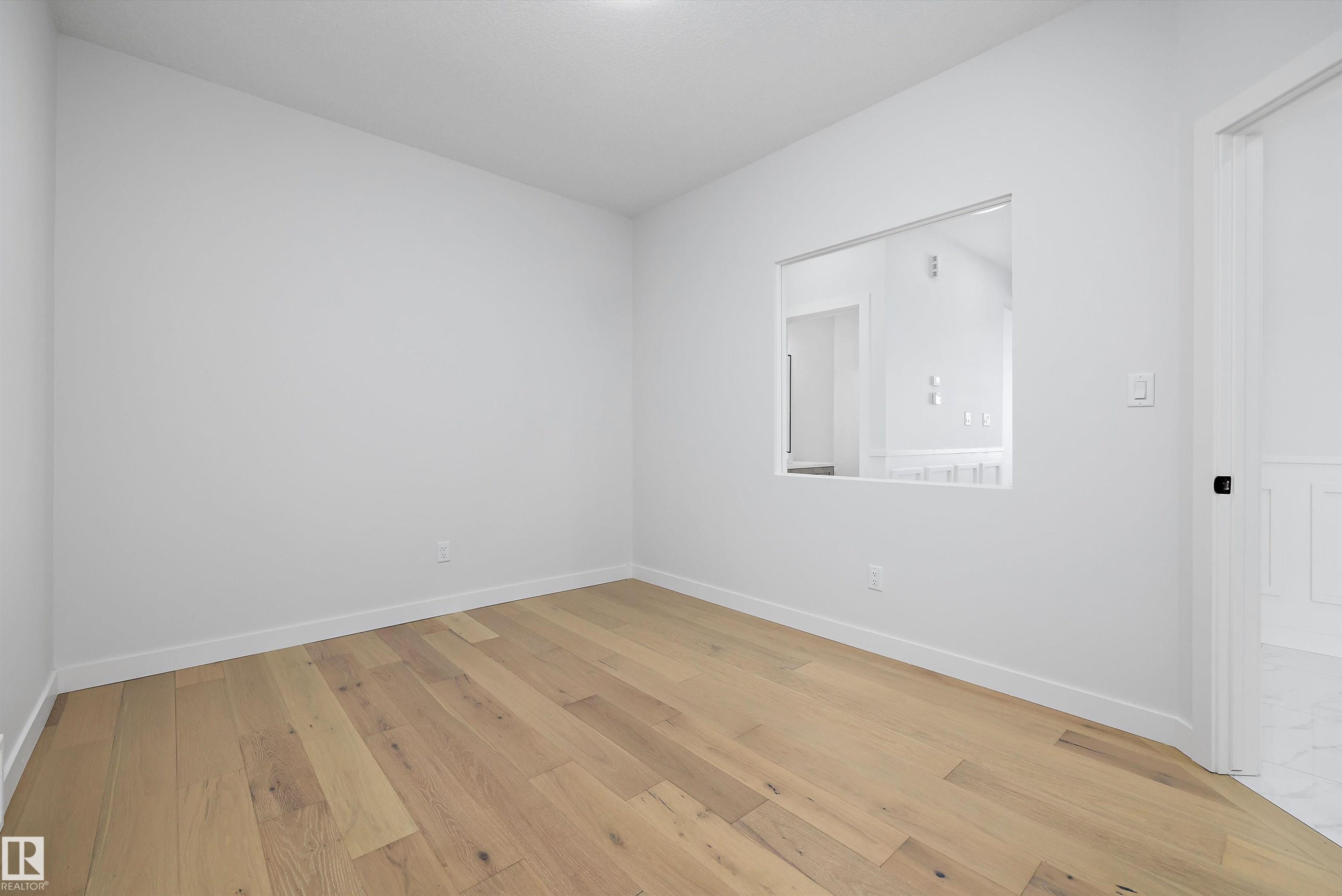 Empty room with light wood-type flooring and baseboards - 230 Edgemont Green Green Nw, Edmonton, AB - Indoor Photo Showing Other Room