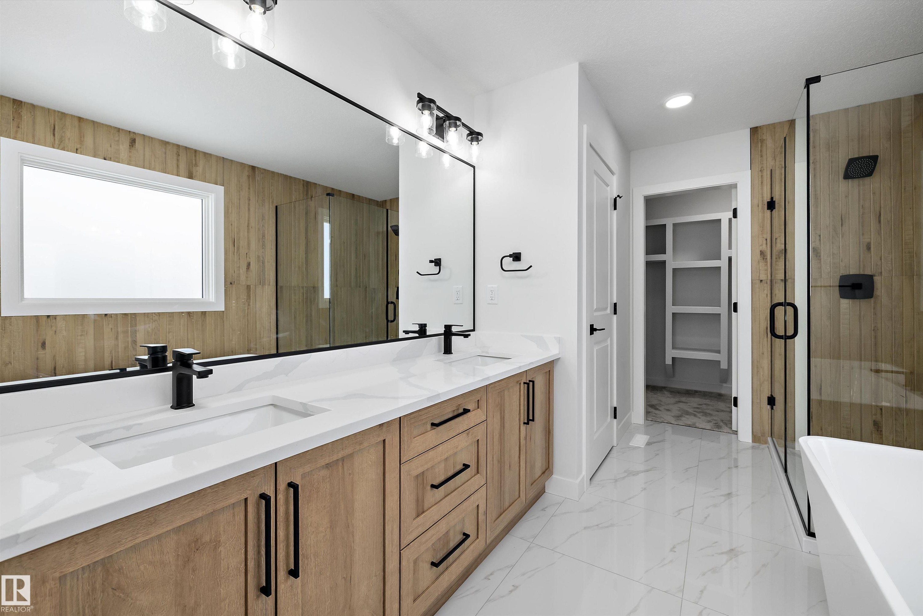 Bathroom featuring double vanity, a soaking tub, a shower stall, a spacious closet, and light marble finish flooring - 230 Edgemont Green Green Nw, Edmonton, AB - Indoor Photo Showing Bathroom