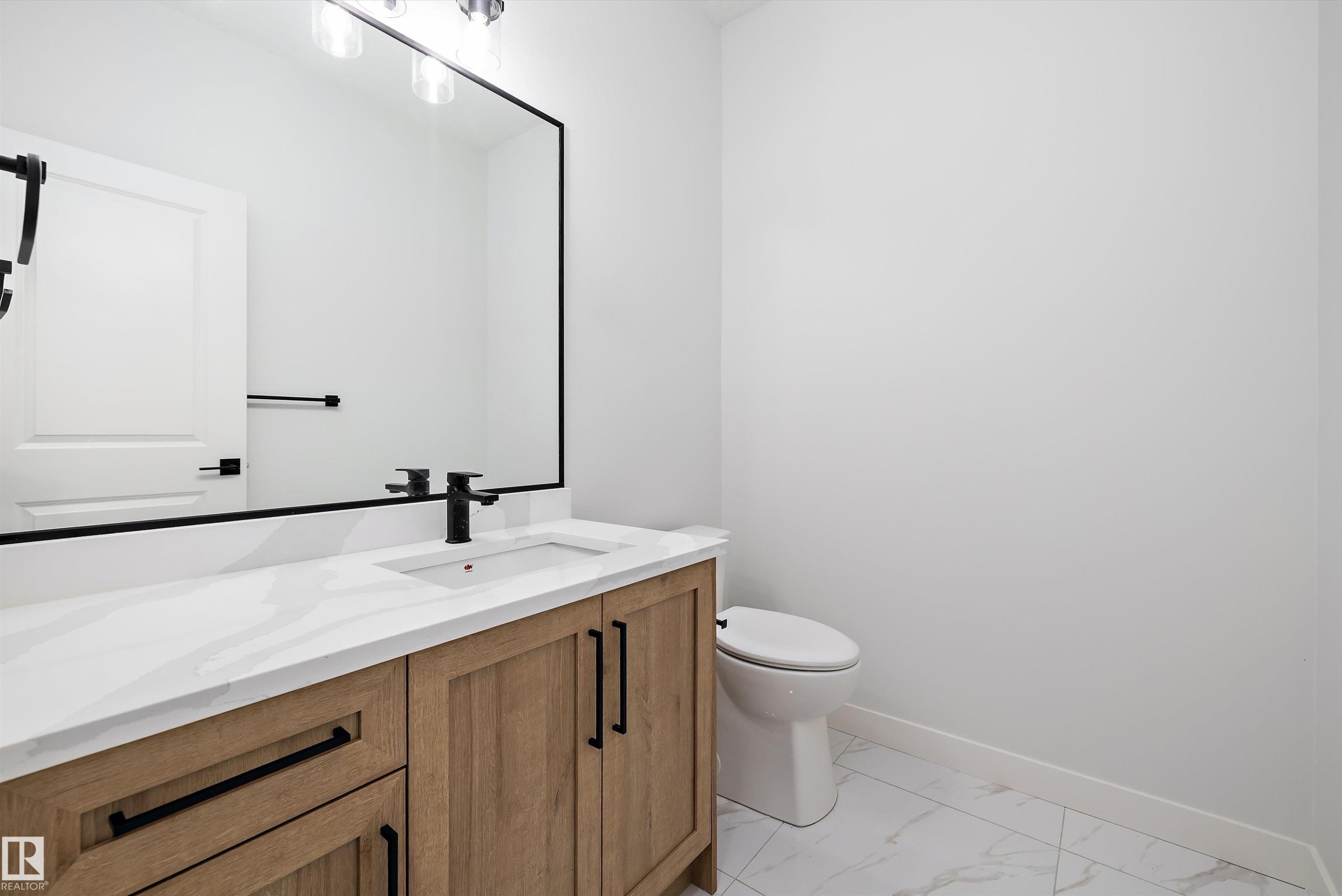 Half bathroom featuring vanity and light marble finish floors - 230 Edgemont Green Green Nw, Edmonton, AB - Indoor Photo Showing Bathroom