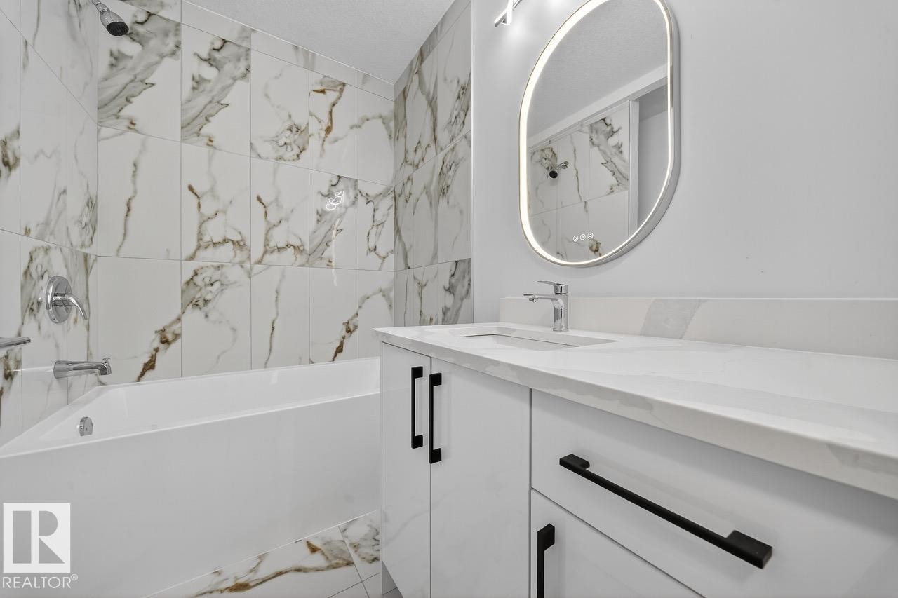 Bathroom featuring shower / tub combination and vanity - 12919 113A Street, Edmonton, AB - Indoor Photo Showing Bathroom