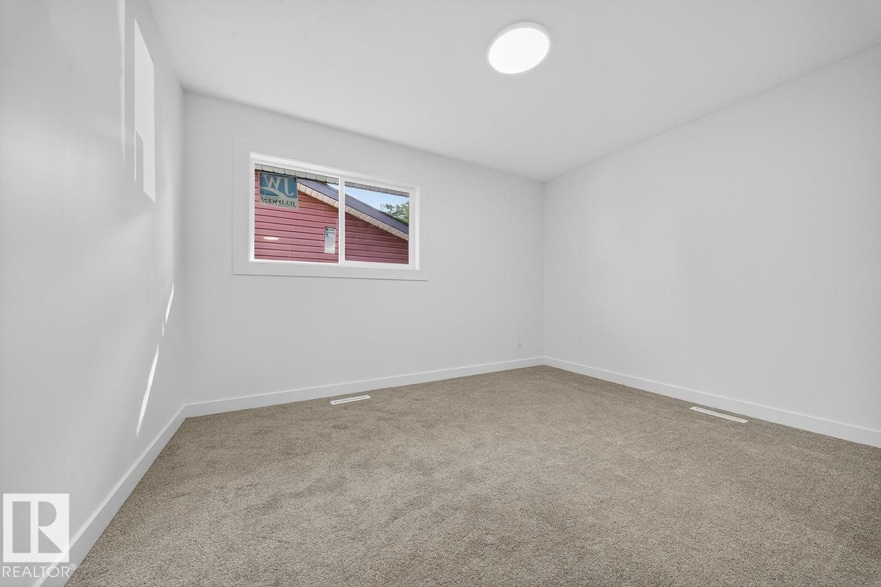 Spare room with baseboards and light carpet - 12919 113A Street, Edmonton, AB - Indoor Photo Showing Other Room