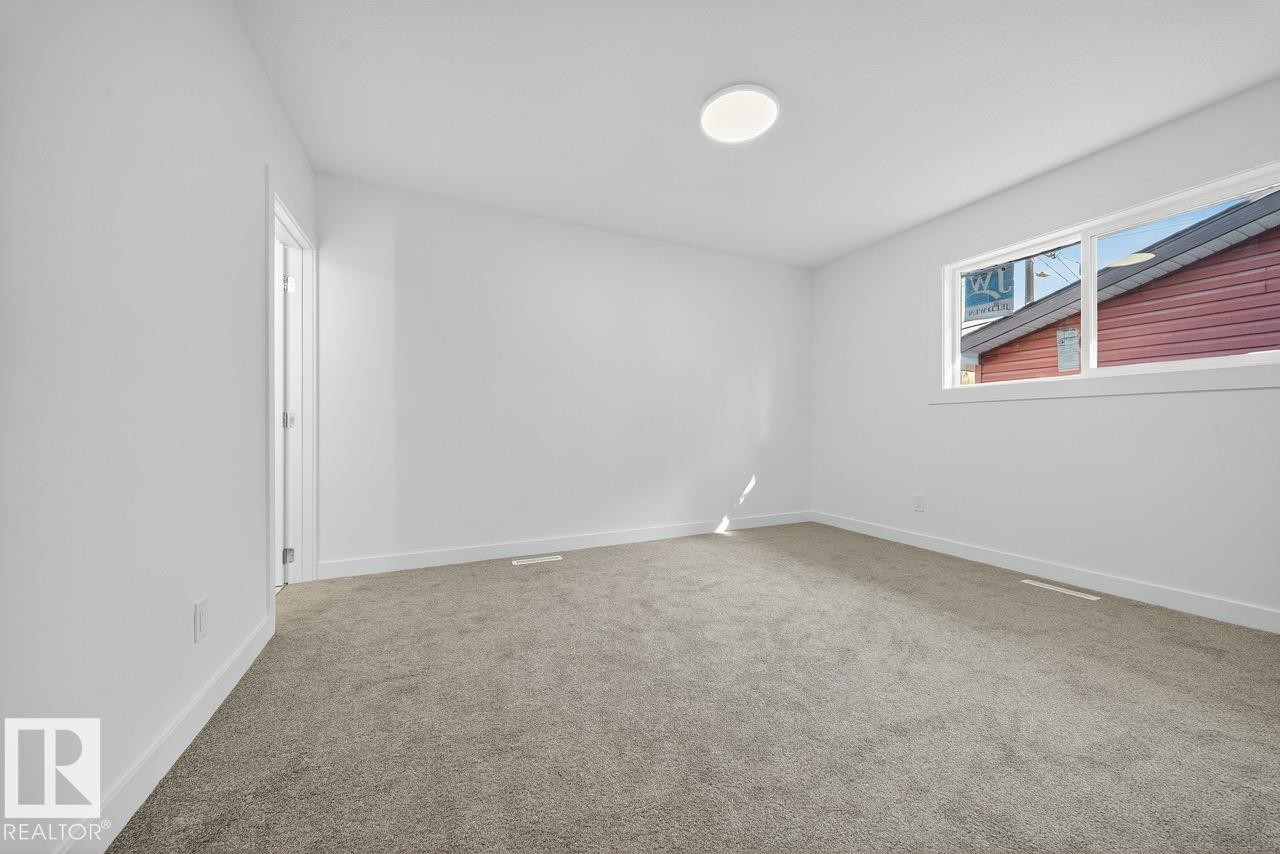 Unfurnished room featuring baseboards and light colored carpet - 12919 113A Street, Edmonton, AB - Indoor Photo Showing Other Room