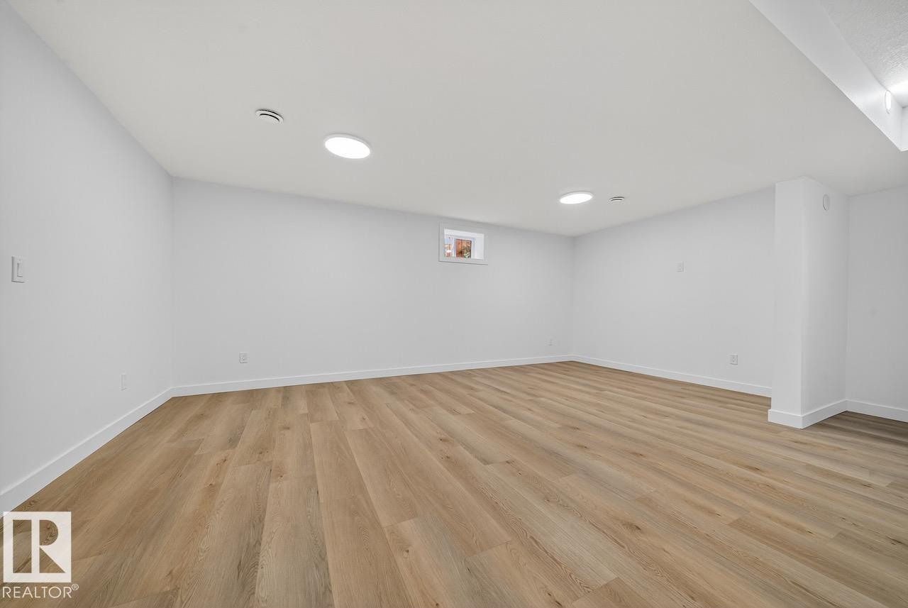 Unfurnished room with light wood-style flooring - 12919 113A Street, Edmonton, AB - Indoor Photo Showing Other Room