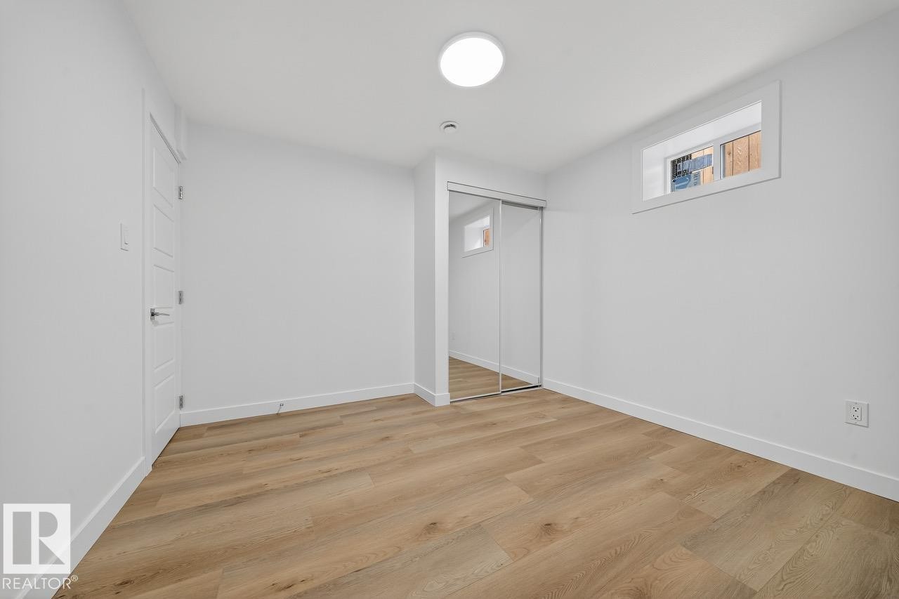 Unfurnished bedroom featuring light wood finished floors and a closet - 12919 113A Street, Edmonton, AB - Indoor Photo Showing Other Room