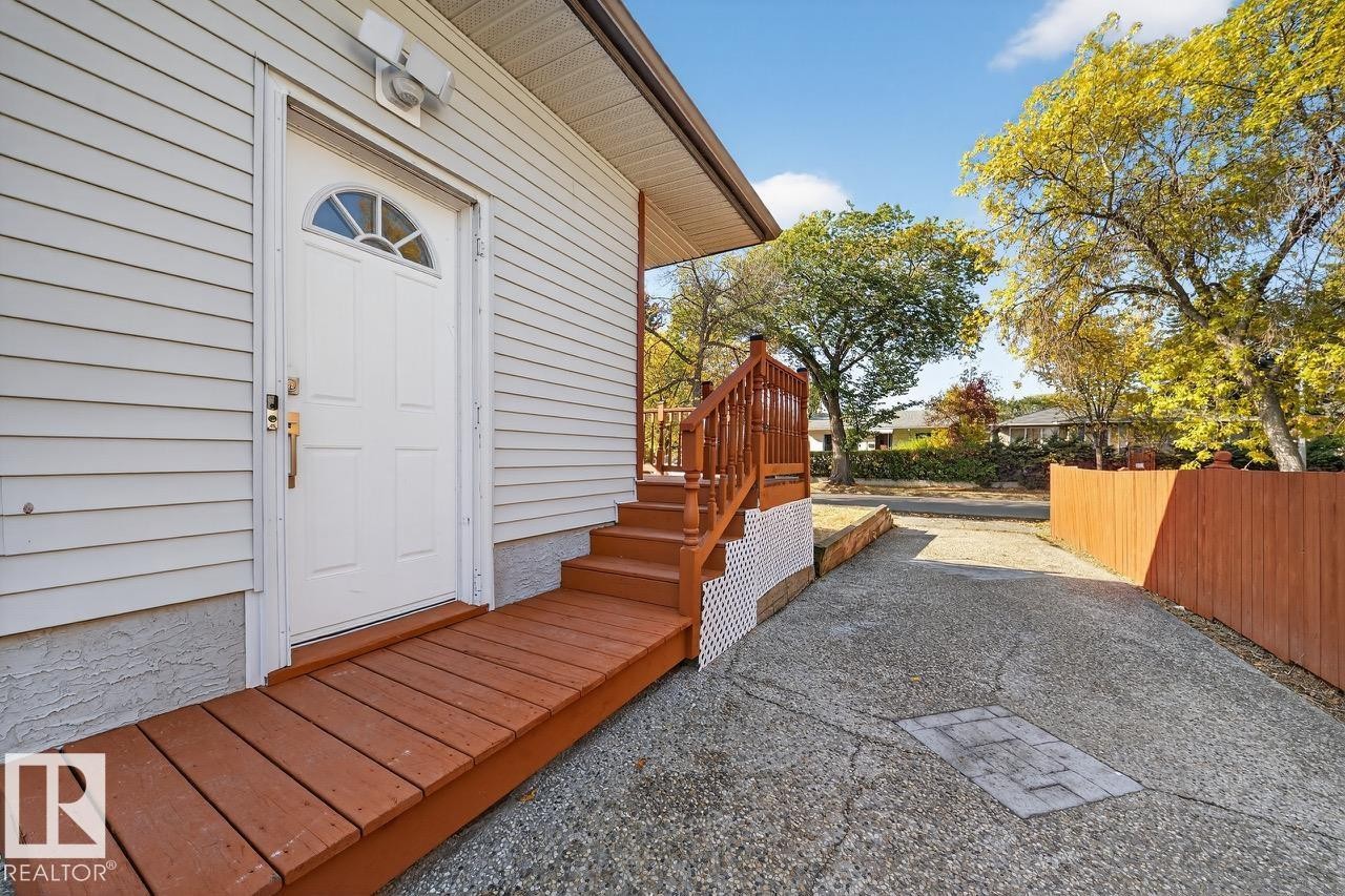 Doorway to property featuring a wooden deck - 12919 113A Street, Edmonton, AB - Outdoor With Exterior
