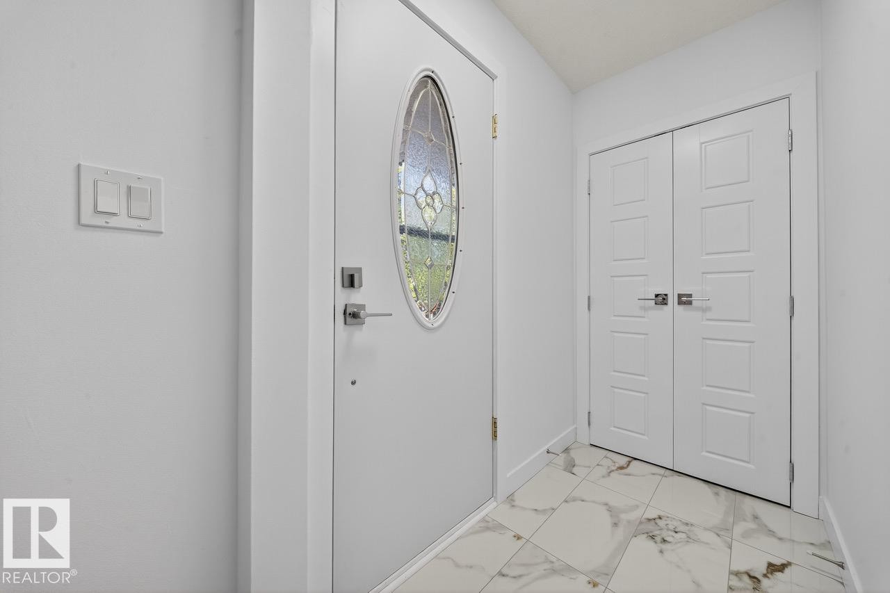 Entrance foyer with light marble finish floors and baseboards - 12919 113A Street, Edmonton, AB - Indoor Photo Showing Other Room