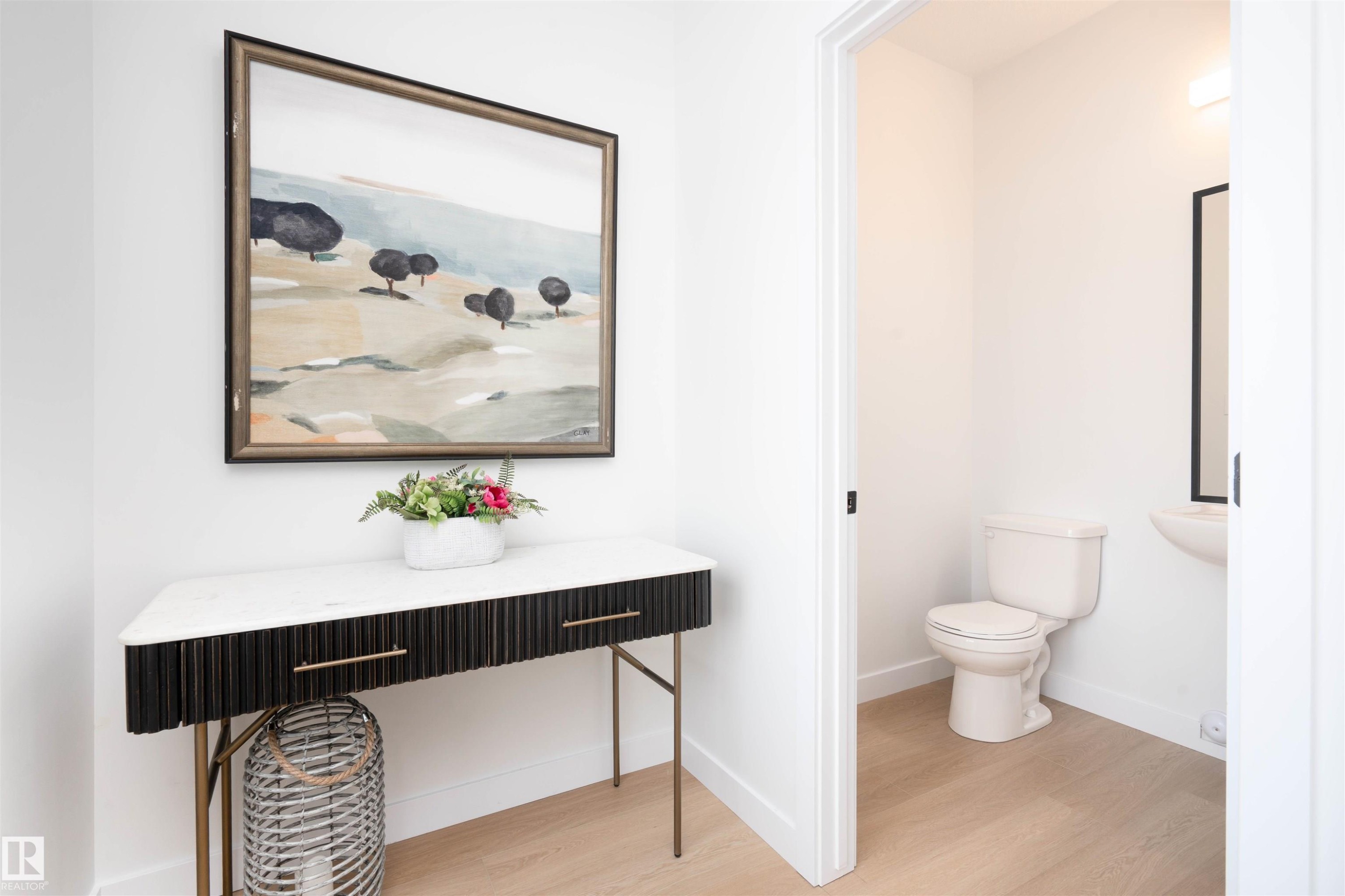Half bath featuring light wood-type flooring - 64 18120 28 Avenue Sw, Edmonton, AB - Indoor Photo Showing Bathroom