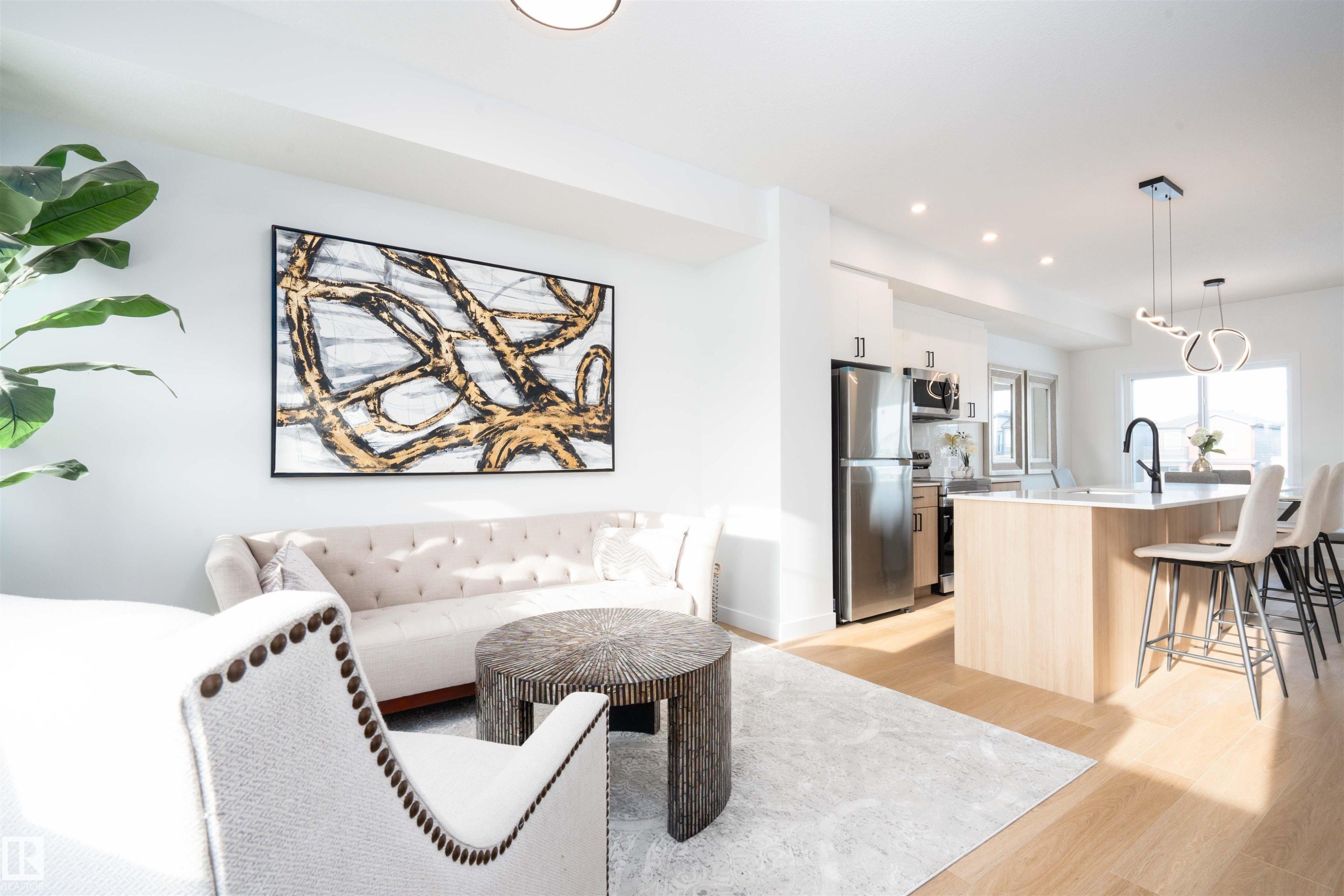 Living area featuring light wood-style flooring and recessed lighting - 64 18120 28 Avenue Sw, Edmonton, AB - Indoor