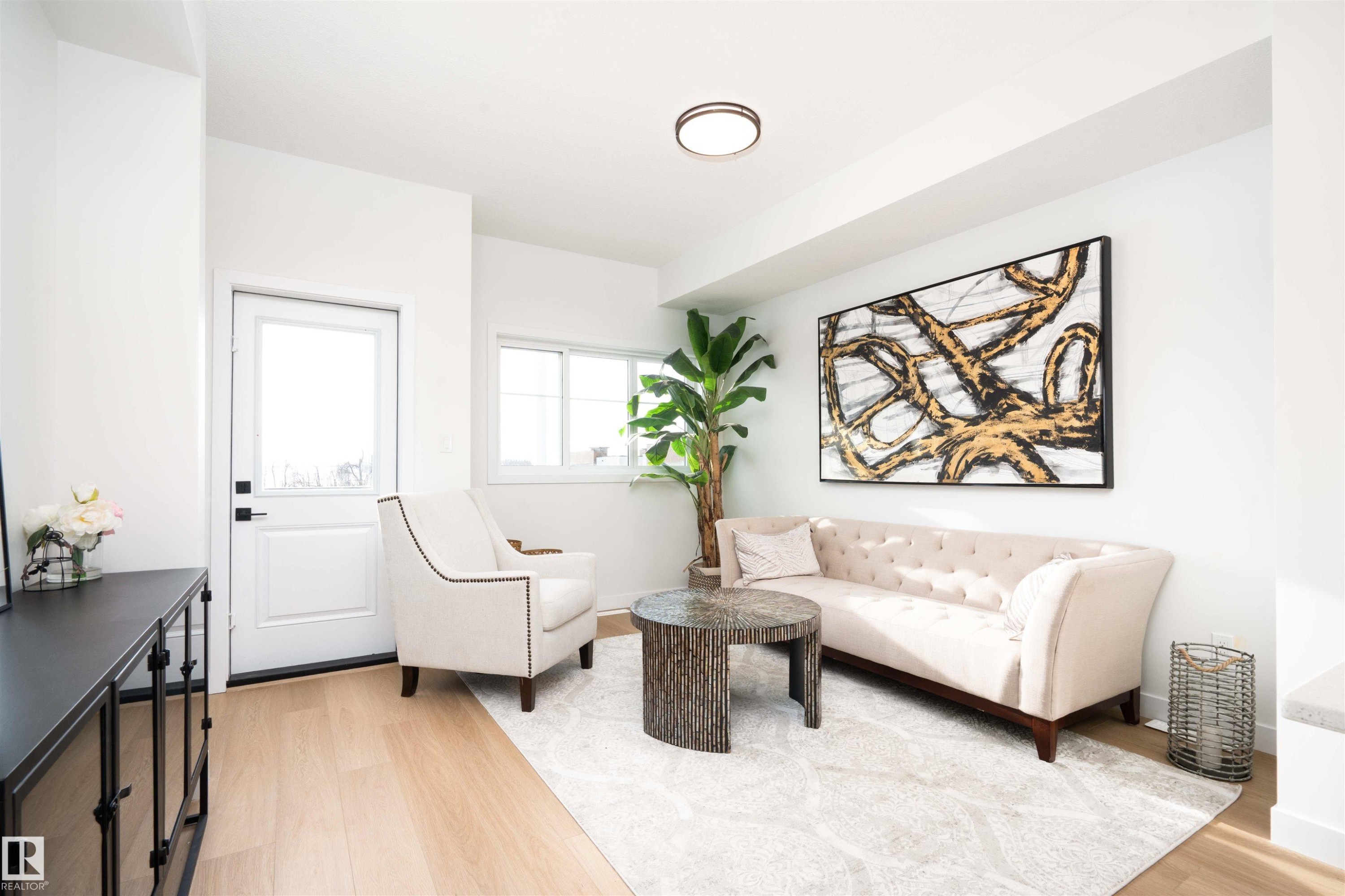 Living room featuring light wood-style floors - 64 18120 28 Avenue Sw, Edmonton, AB - Indoor