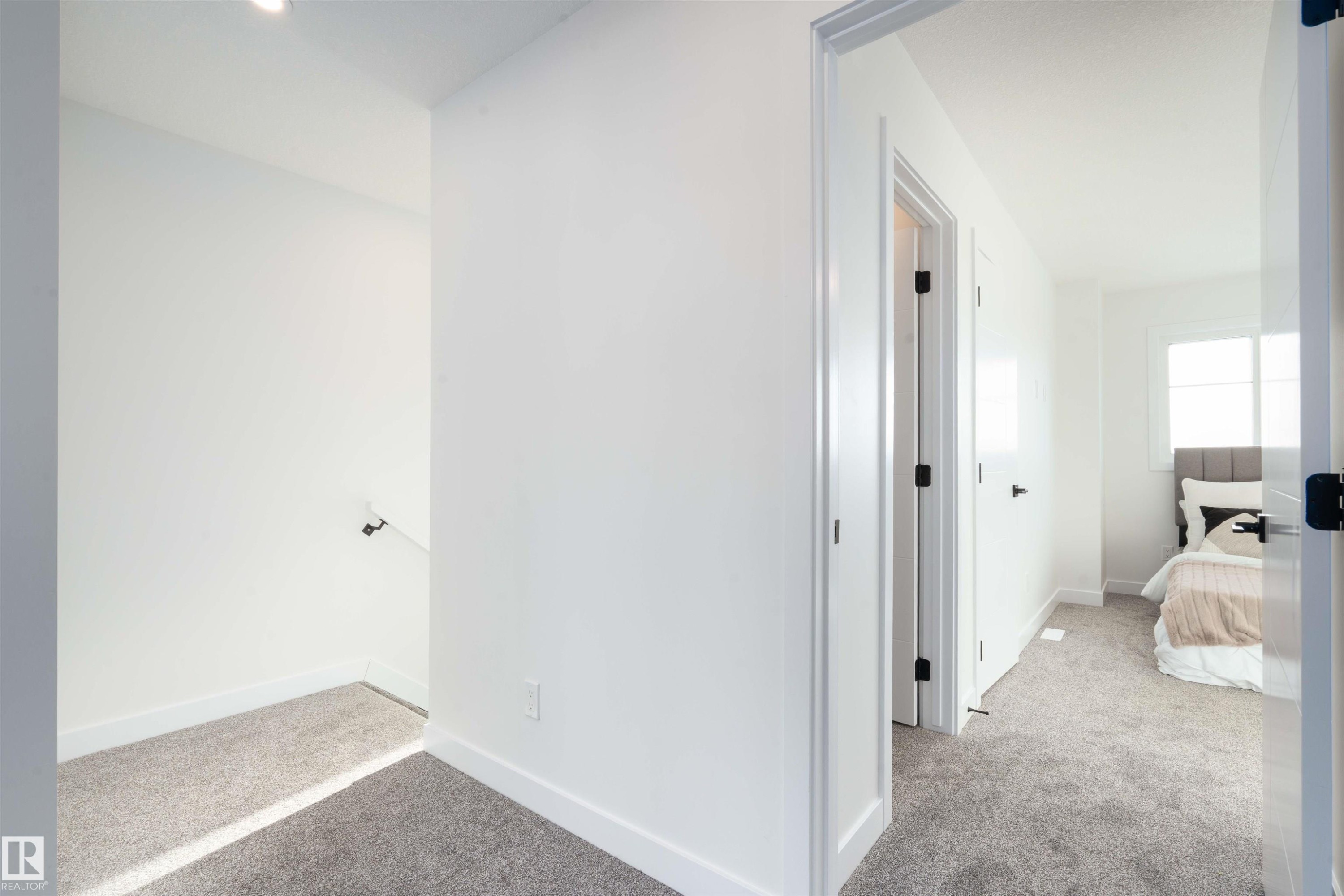 Hall with light colored carpet and baseboards - 64 18120 28 Avenue Sw, Edmonton, AB - Indoor Photo Showing Other Room
