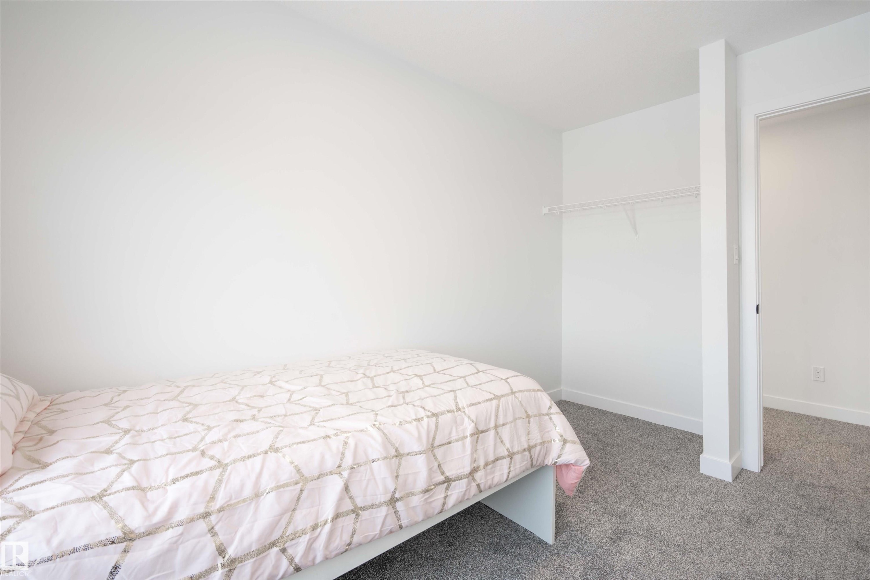 Bedroom featuring carpet flooring and baseboards - 64 18120 28 Avenue Sw, Edmonton, AB - Indoor Photo Showing Bedroom