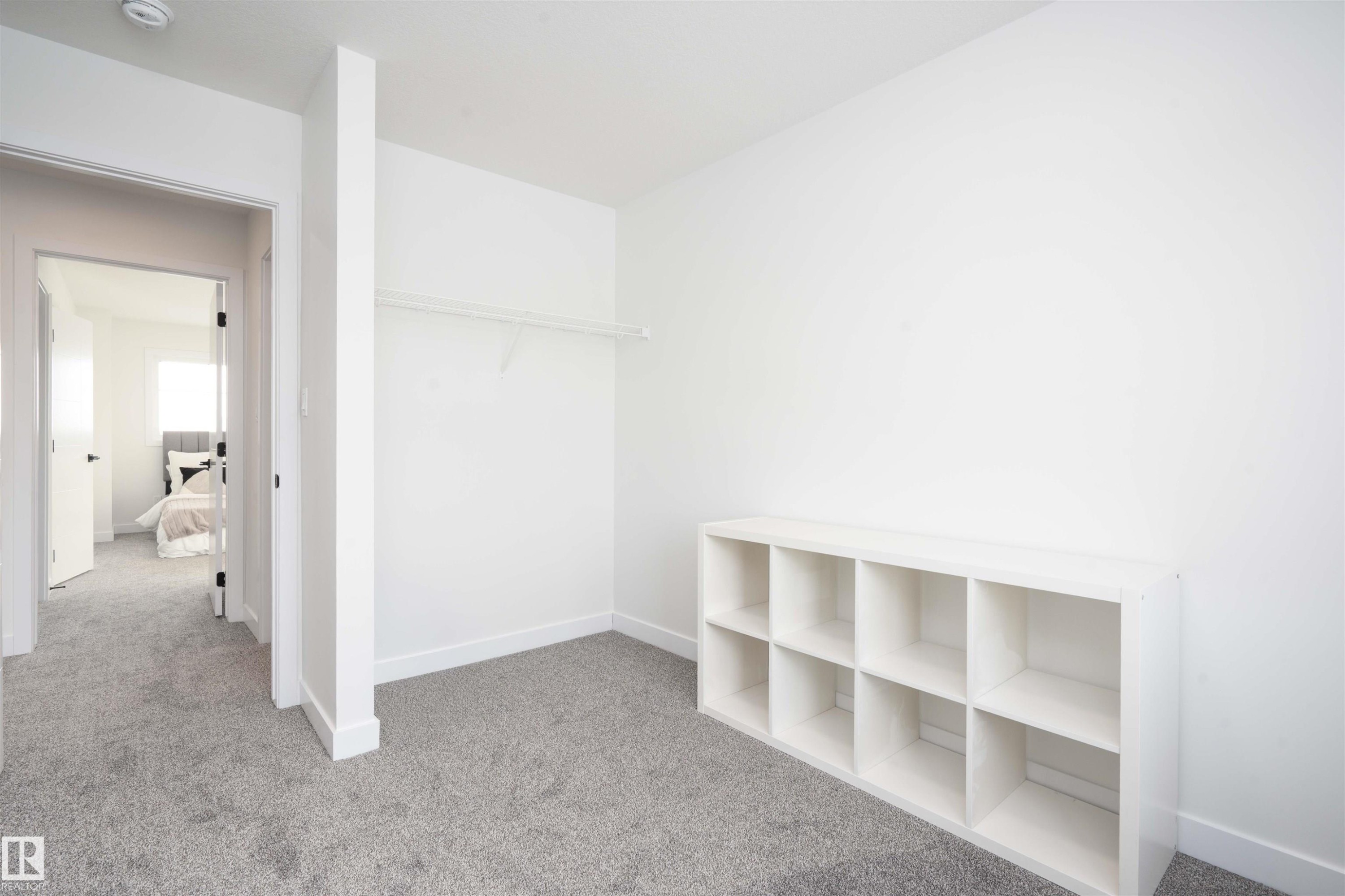 Walk in closet featuring carpet flooring - 64 18120 28 Avenue Sw, Edmonton, AB - Indoor