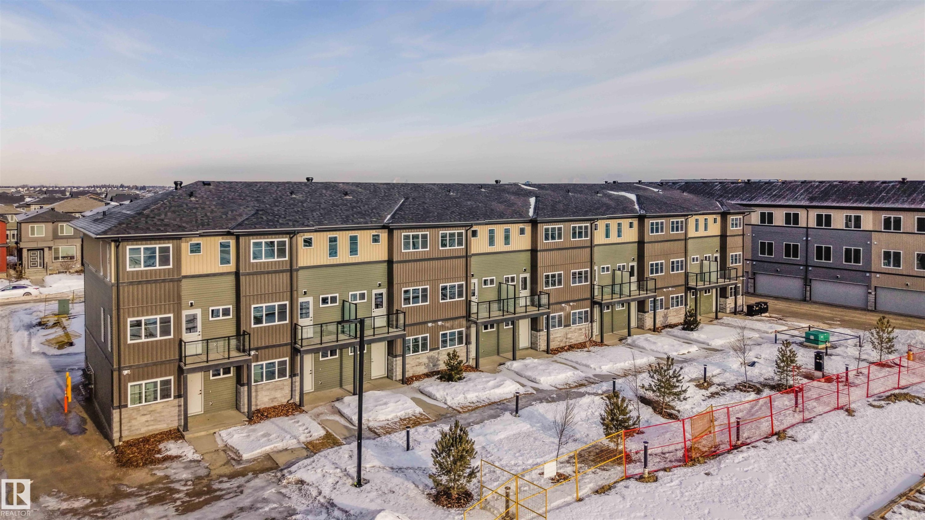 Snow covered building with a view of apartment building / complex - 64 18120 28 Avenue Sw, Edmonton, AB - Outdoor