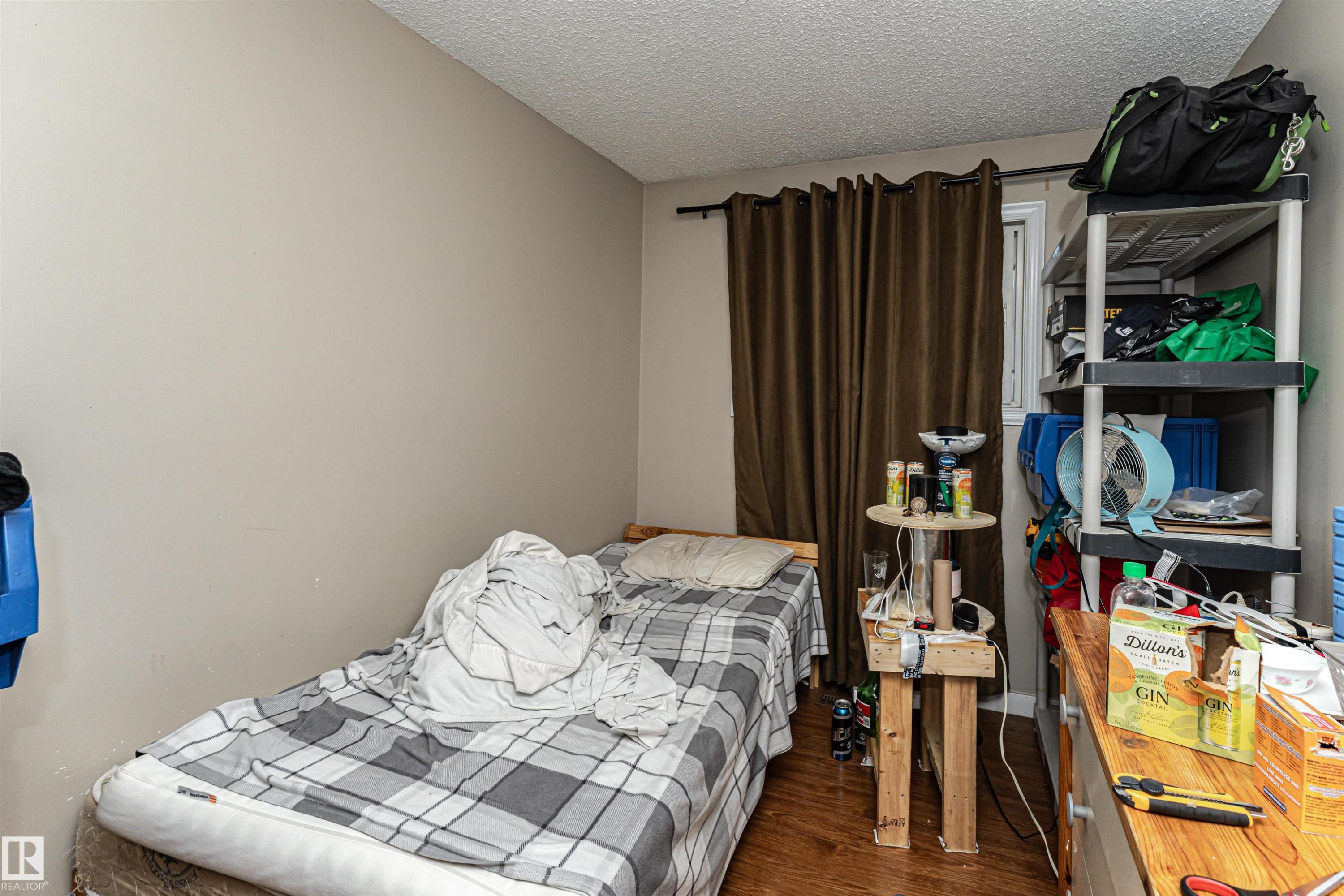 Bedroom featuring a textured ceiling and dark wood-style floors - 2349 Millbourne Road W, Edmonton, AB - Indoor Photo Showing Bedroom