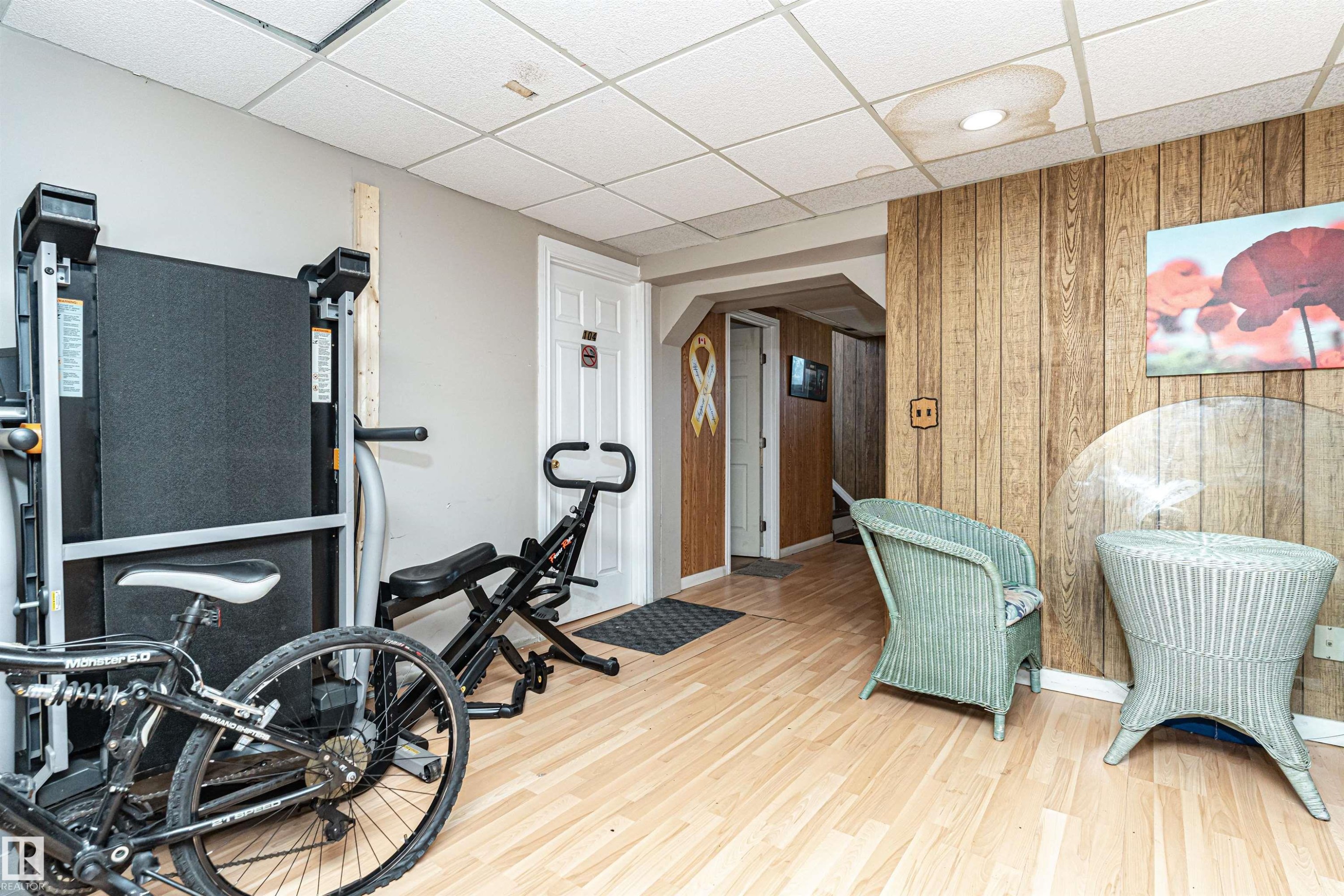 Exercise room featuring wooden walls, a paneled ceiling, and arched walkways - 2349 Millbourne Road W, Edmonton, AB - Indoor Photo Showing Gym Room