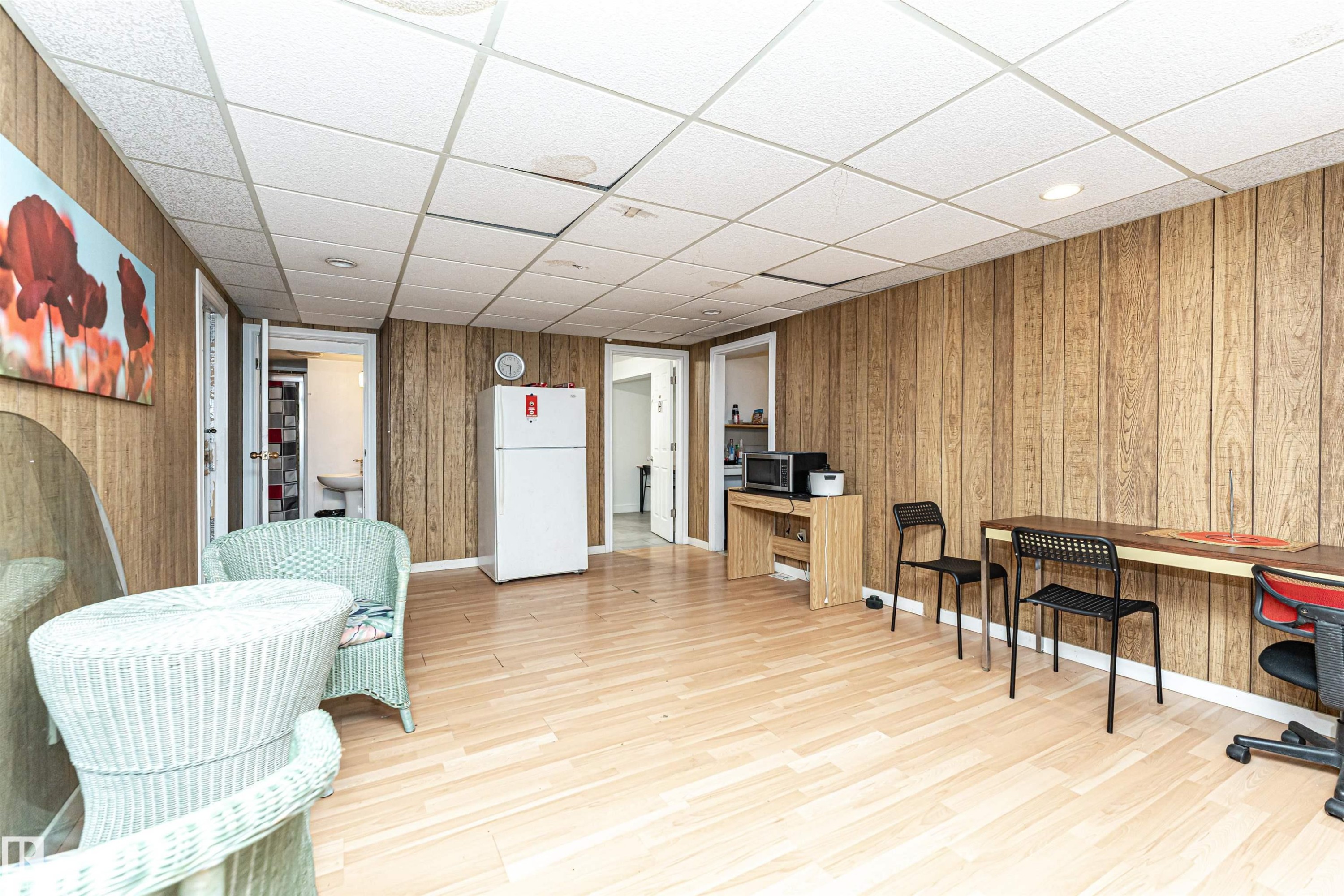 Office with a drop ceiling, wood walls, and light wood-type flooring - 2349 Millbourne Road W, Edmonton, AB - Indoor