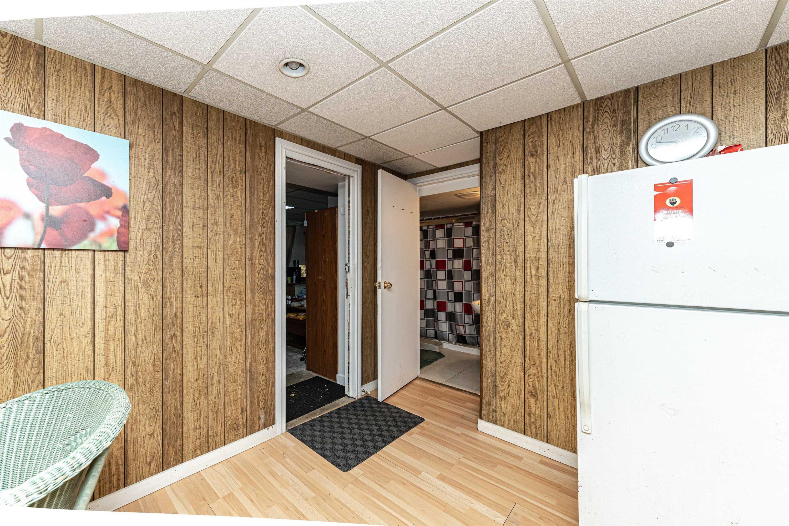 Interior space featuring a drop ceiling, wooden walls, and light wood-type flooring - 2349 Millbourne Road W, Edmonton, AB - Indoor Photo Showing Other Room