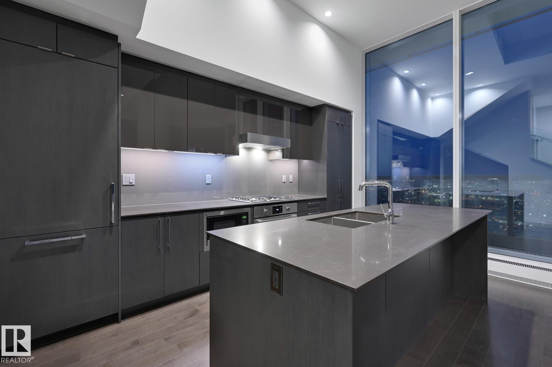 Kitchen with modern cabinets, light wood-type flooring, an island with sink, stainless steel appliances, and recessed lighting - 2303 10360 102 Street, Edmonton, AB - Indoor Photo Showing Kitchen With Double Sink With Upgraded Kitchen