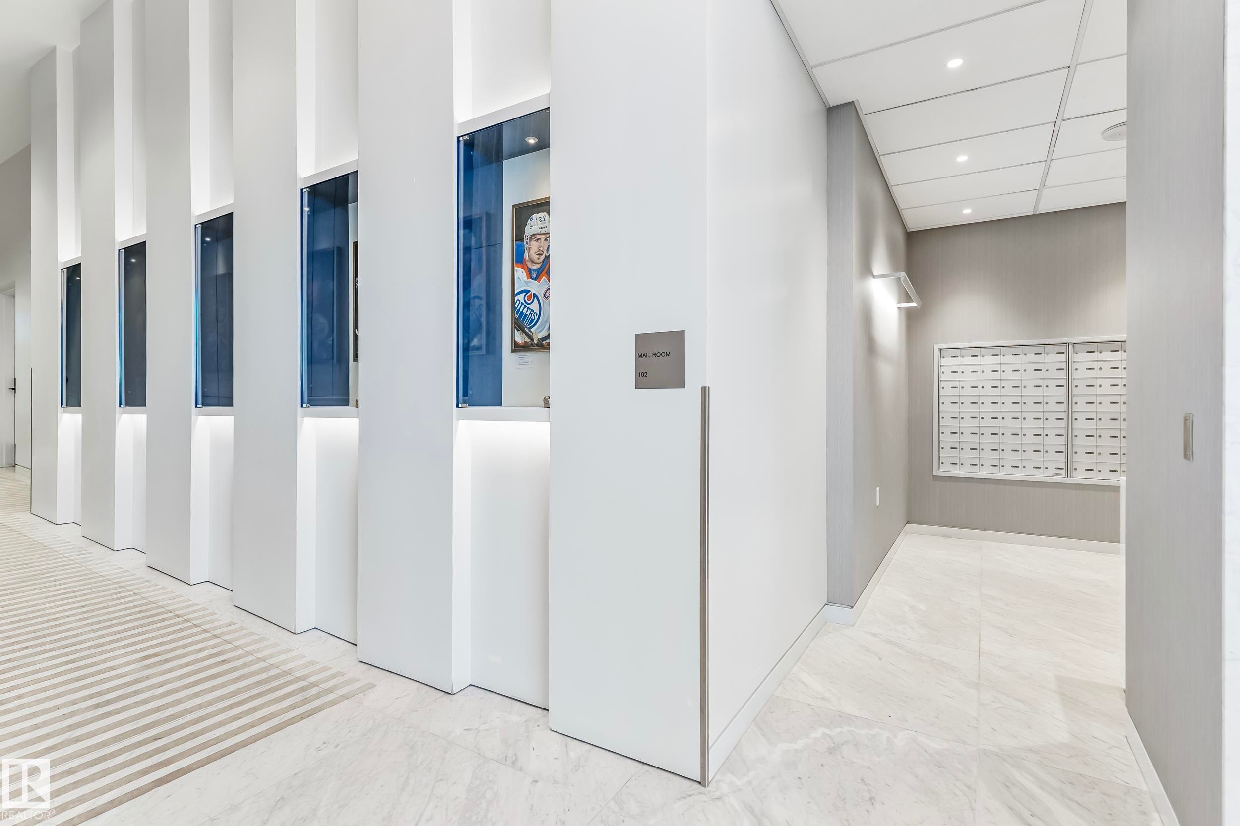 Hall featuring mail area, light marble finish flooring, recessed lighting, and a paneled ceiling - 2303 10360 102 Street, Edmonton, AB - Indoor Photo Showing Other Room