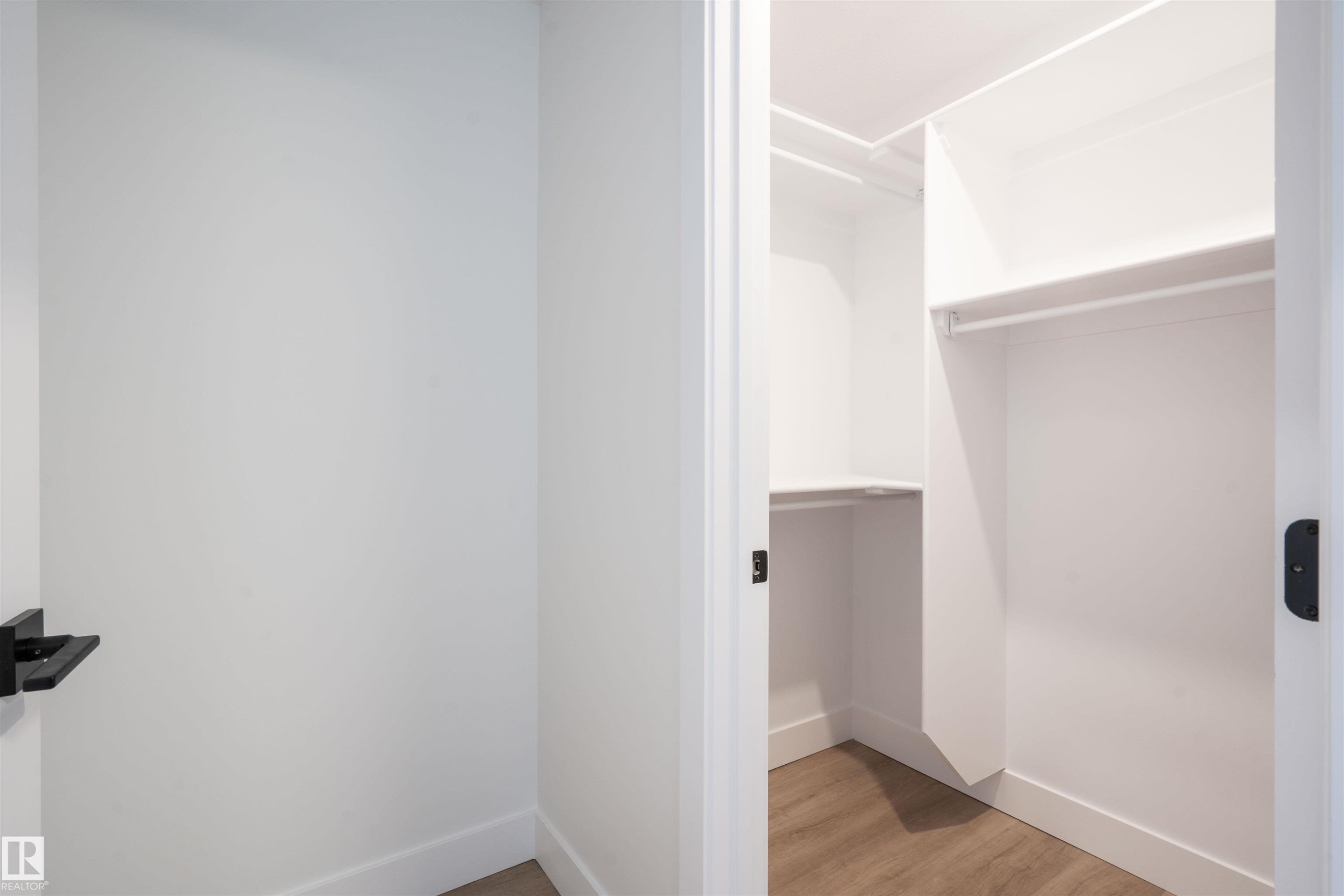 Spacious closet featuring light wood finished floors - 430 Crystal Creek Link, Leduc, AB - Indoor Photo Showing Other Room