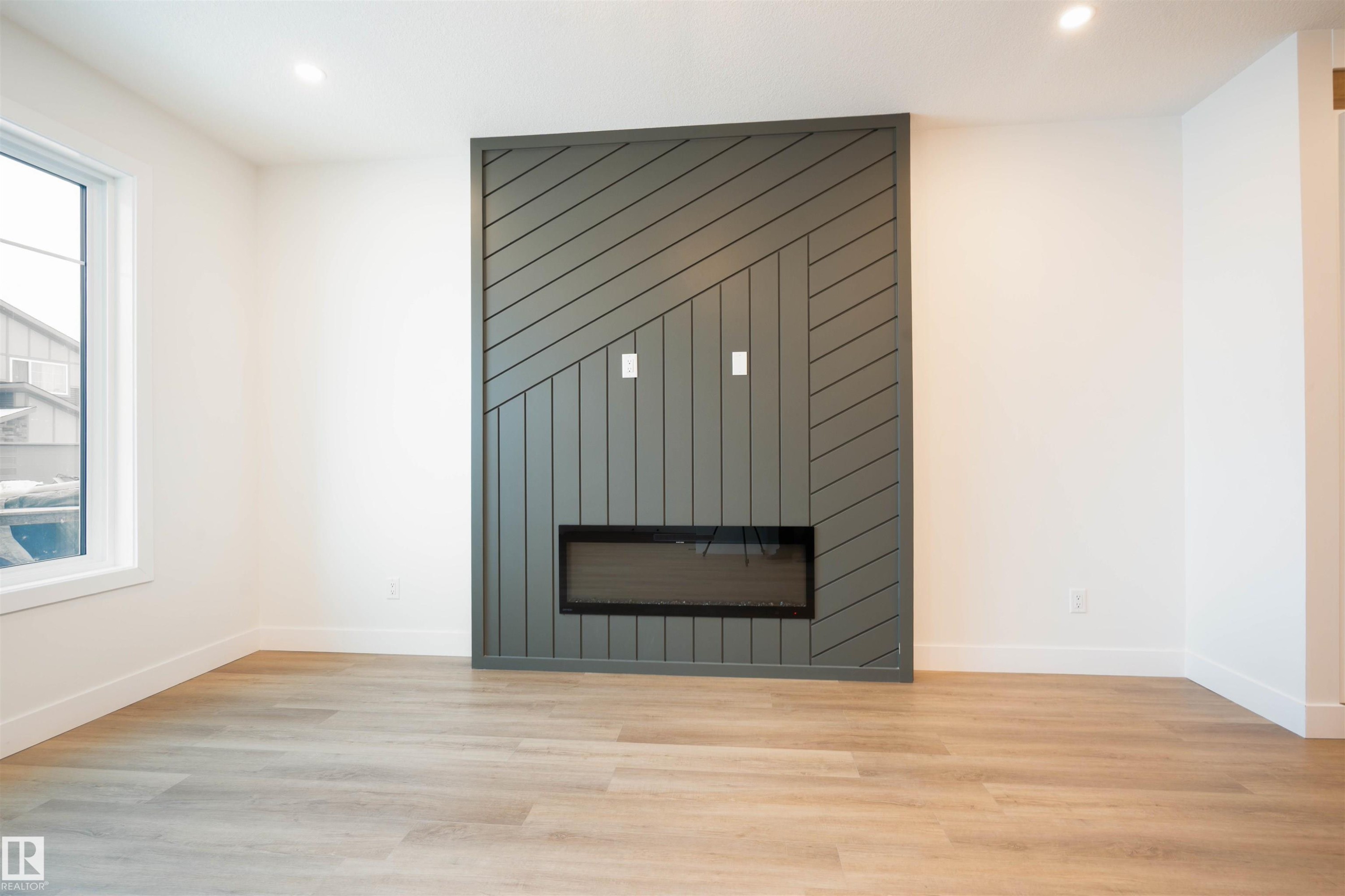 Detailed view of wood finished floors, a fireplace, and recessed lighting - 430 Crystal Creek Link, Leduc, AB - Indoor With Fireplace