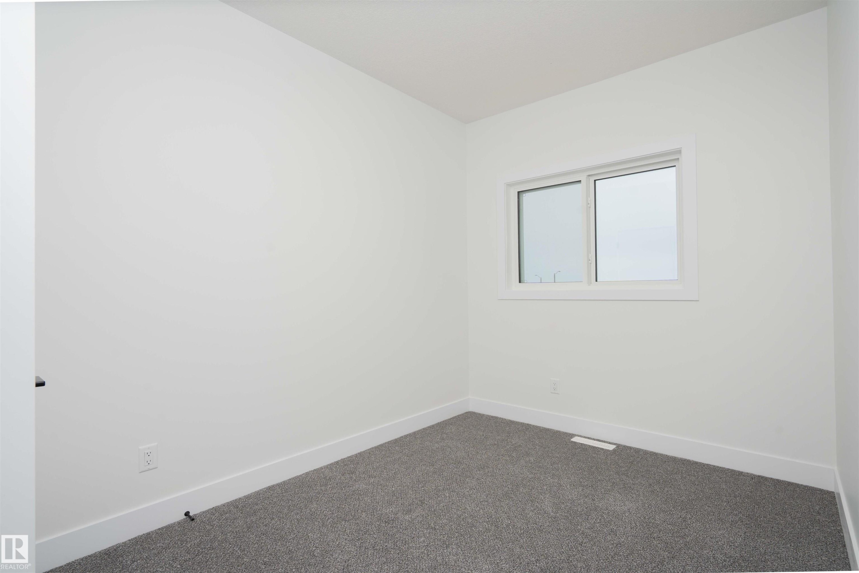 Carpeted spare room with baseboards - 430 Crystal Creek Link, Leduc, AB - Indoor Photo Showing Other Room