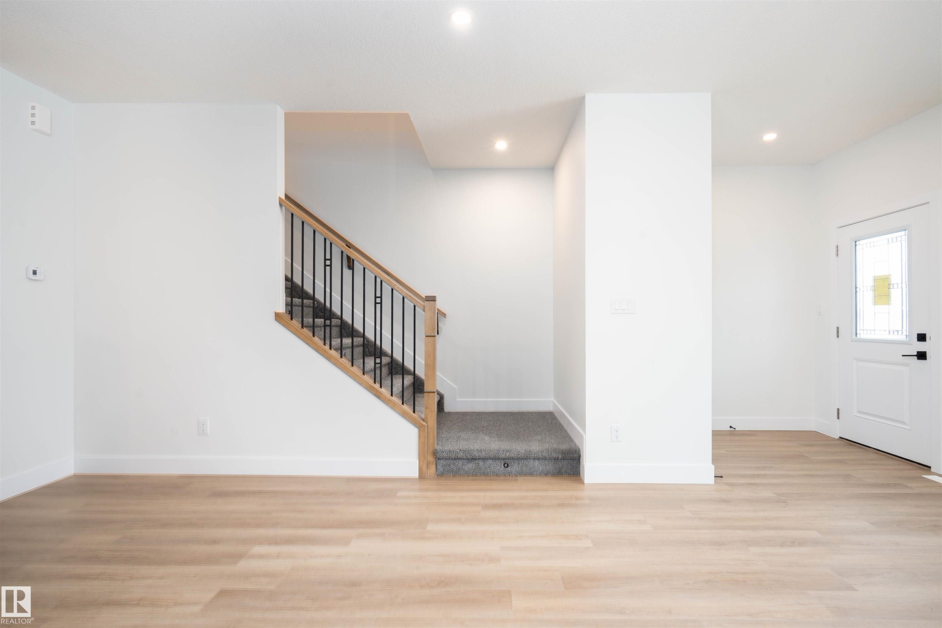 Foyer with light wood-style flooring, recessed lighting, and stairway - 430 Crystal Creek Link, Leduc, AB - Indoor Photo Showing Other Room