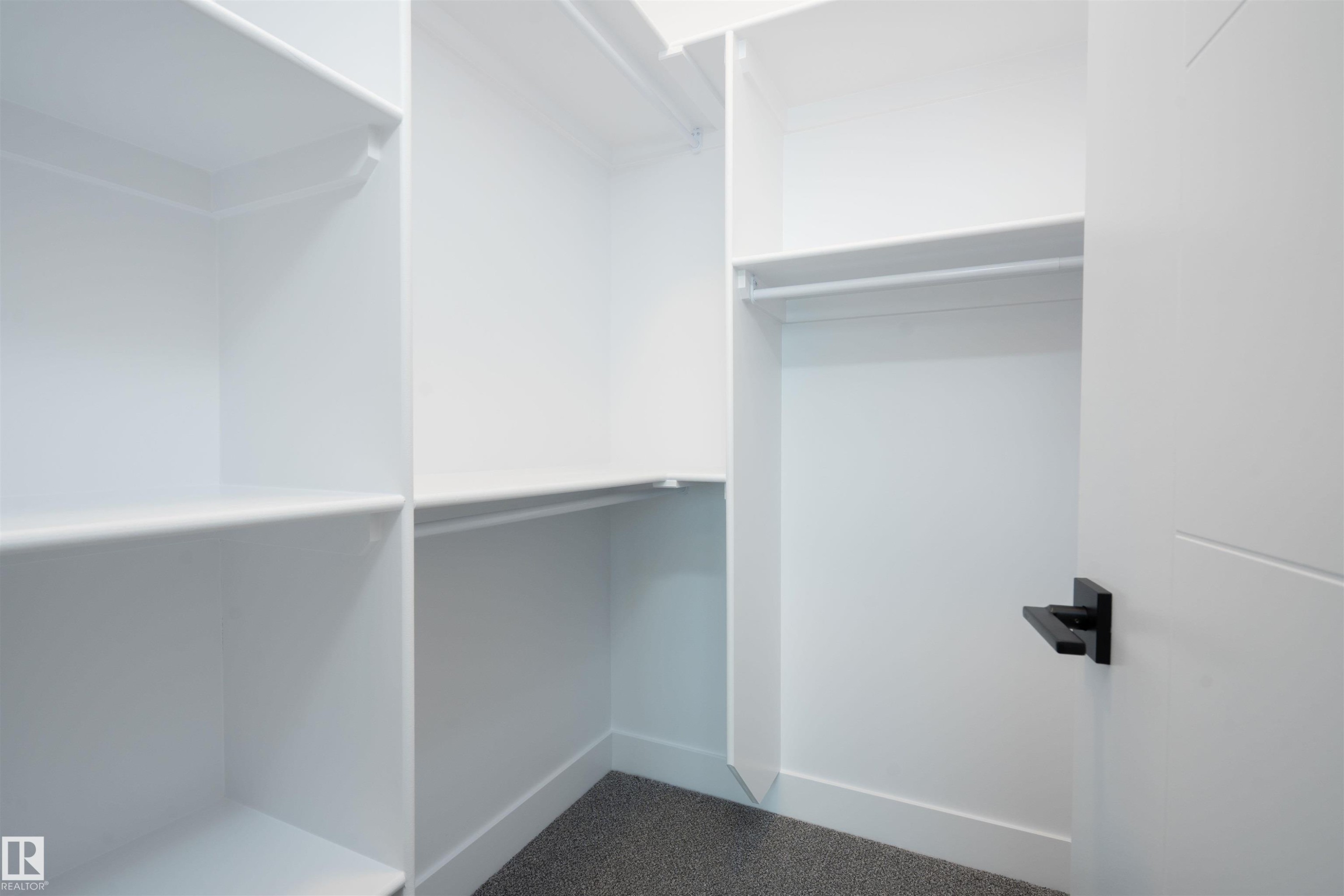 Spacious closet featuring carpet flooring - 430 Crystal Creek Link, Leduc, AB - Indoor With Storage