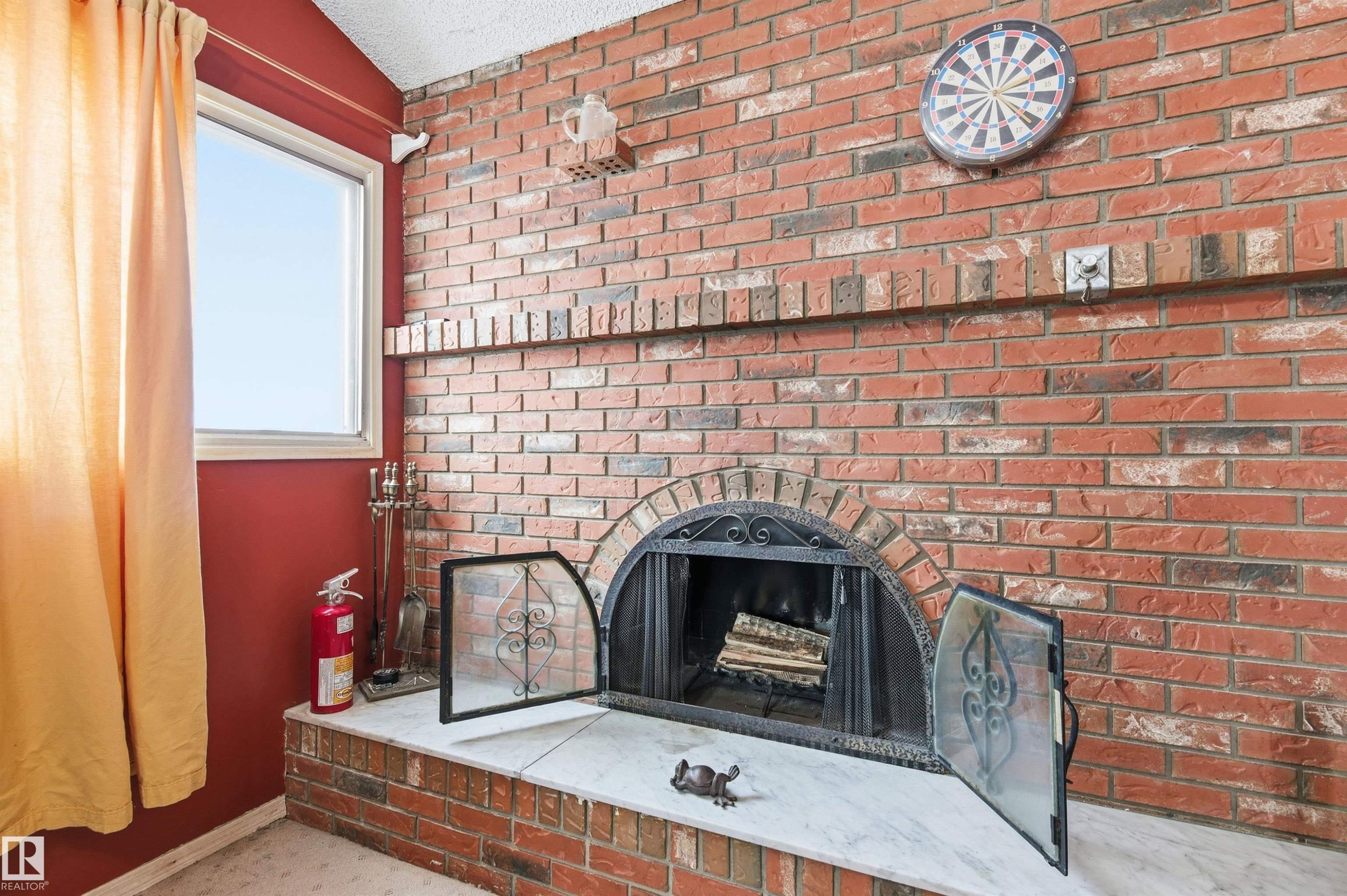 Detailed view of a fireplace and a fire extinguisher - 10332 82 Street, Edmonton, AB - Indoor With Fireplace