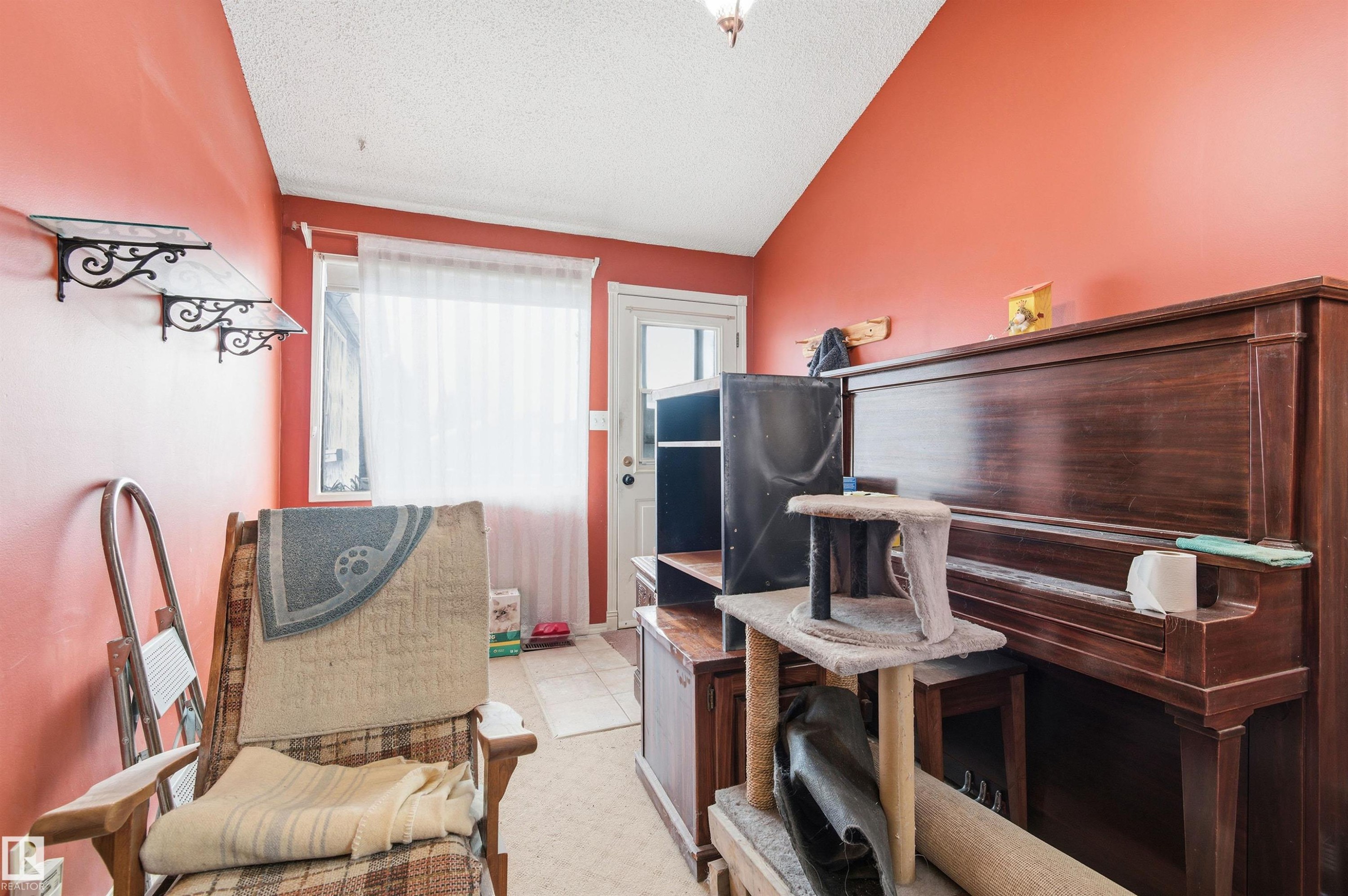 Misc room featuring a textured ceiling, vaulted ceiling, and light tile patterned flooring - 10332 82 Street, Edmonton, AB - Indoor
