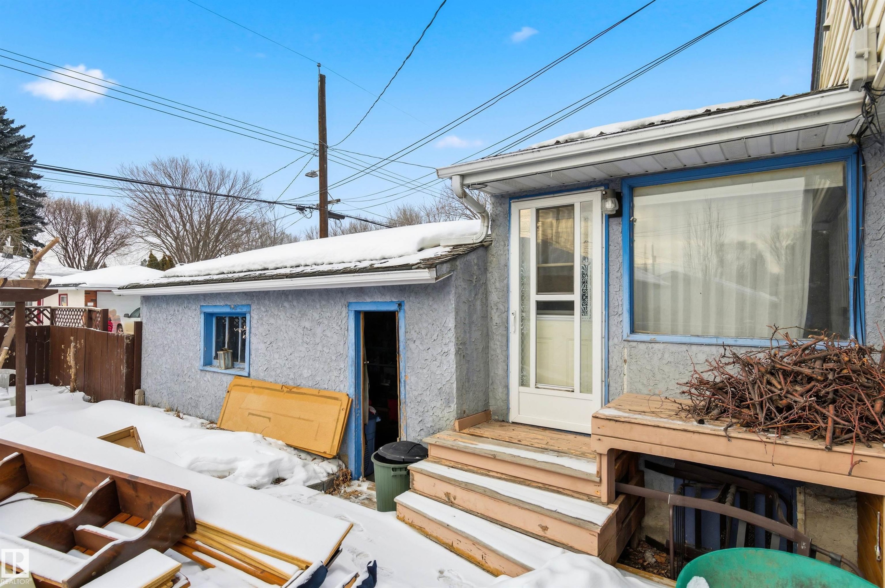 Snow covered property entrance featuring stucco siding - 10332 82 Street, Edmonton, AB - Outdoor