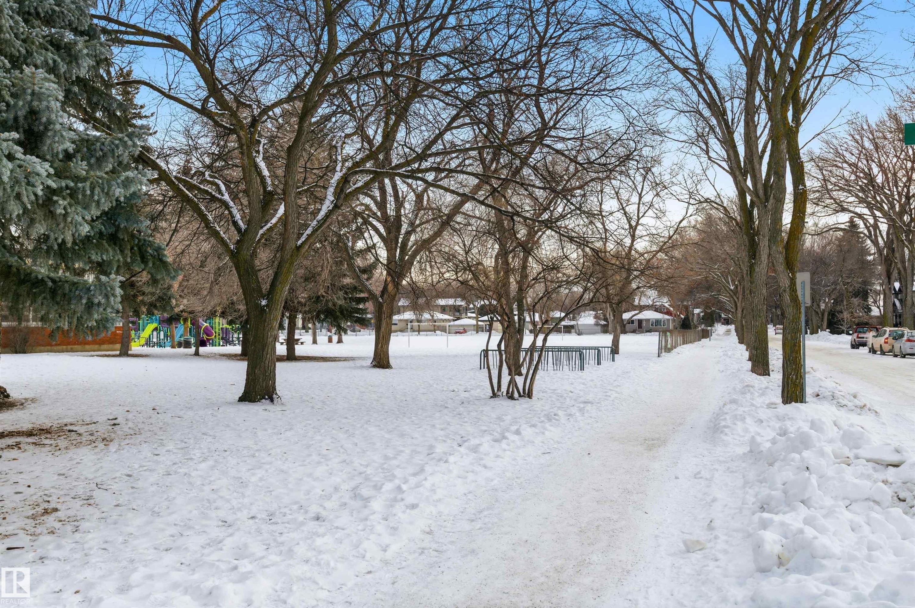 View of snowy yard across the street. - 10332 82 Street, Edmonton, AB - Outdoor With View
