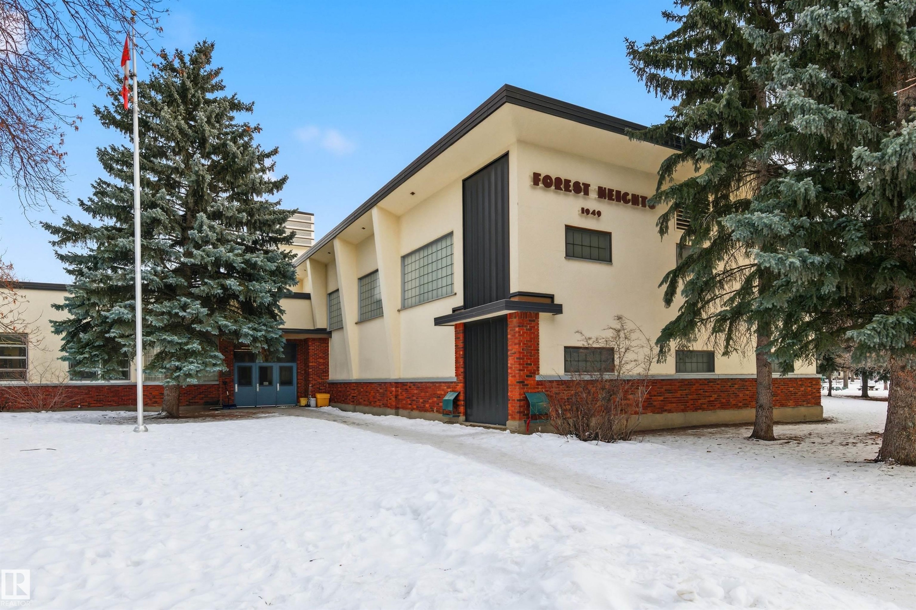 Snow covered property featuring brick siding and stucco siding - 10332 82 Street, Edmonton, AB - Outdoor
