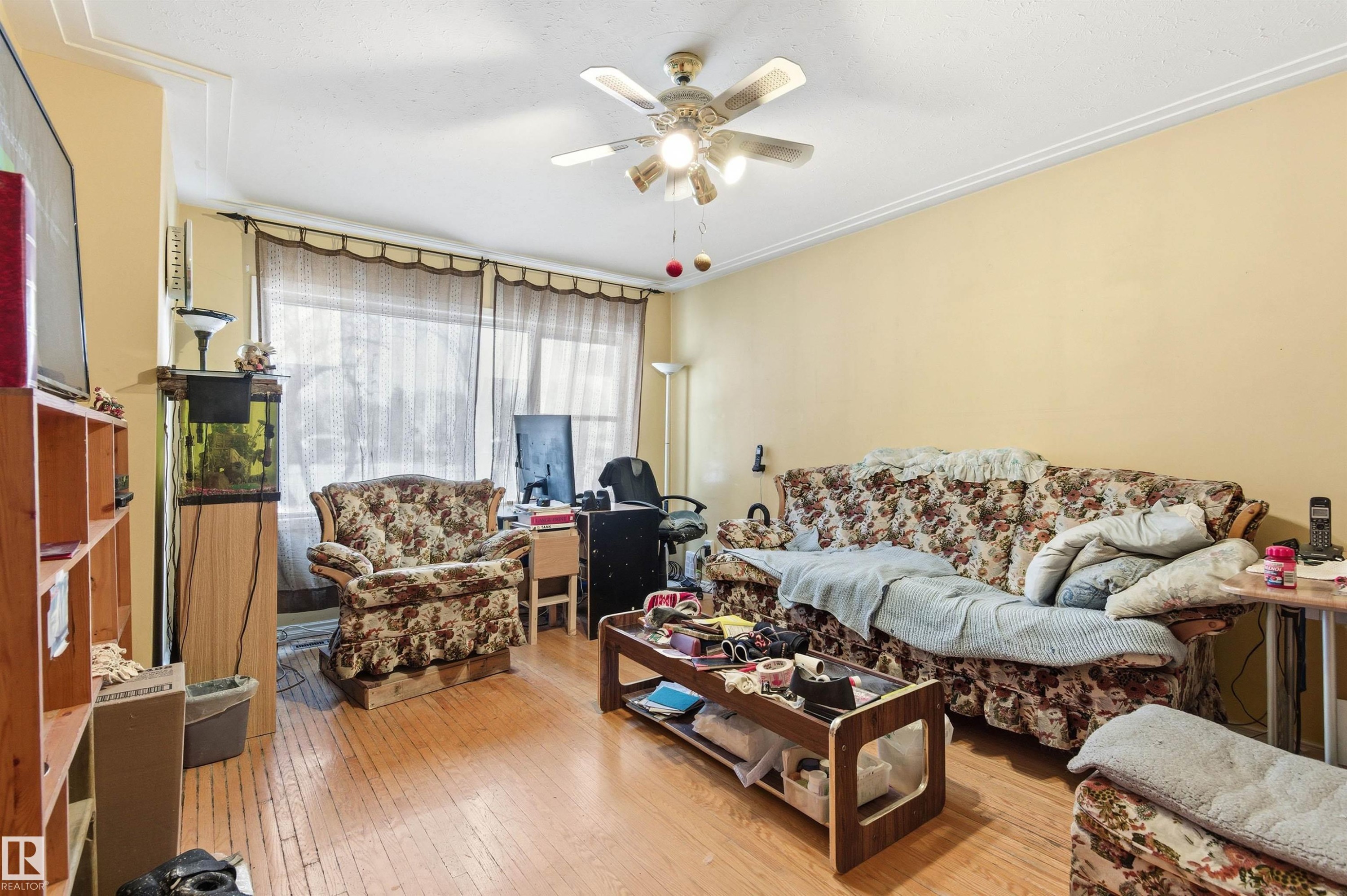 Living area featuring light wood-type flooring and ceiling fan - 10332 82 Street, Edmonton, AB - Indoor Photo Showing Living Room