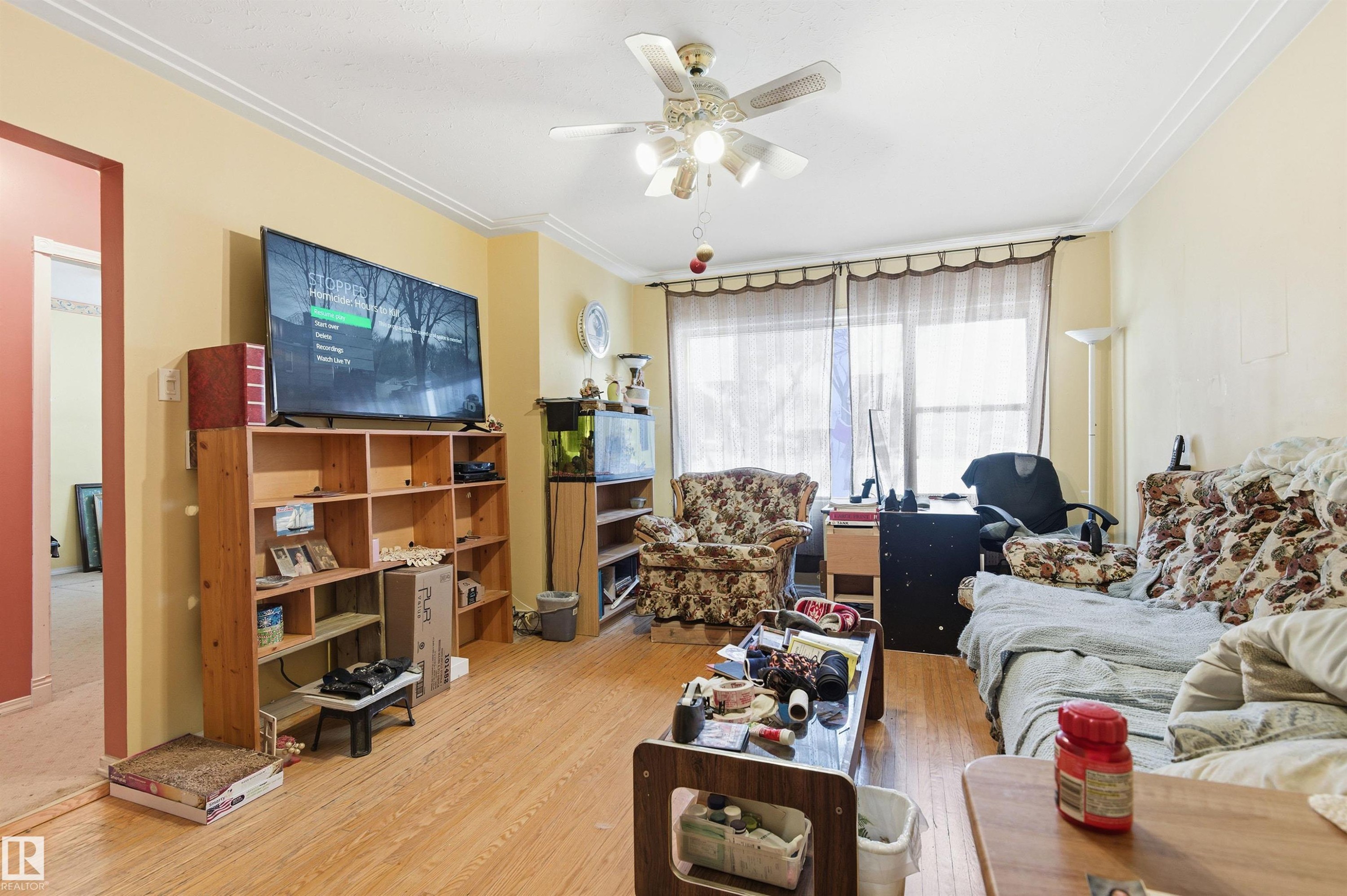 Living area featuring a ceiling fan, crown molding, and wood finished floors - 10332 82 Street, Edmonton, AB - Indoor Photo Showing Living Room