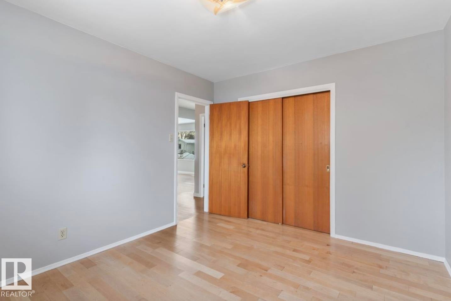 Unfurnished bedroom with light wood-style floors and a closet - 3810 110 Avenue, Edmonton, AB - Indoor Photo Showing Other Room