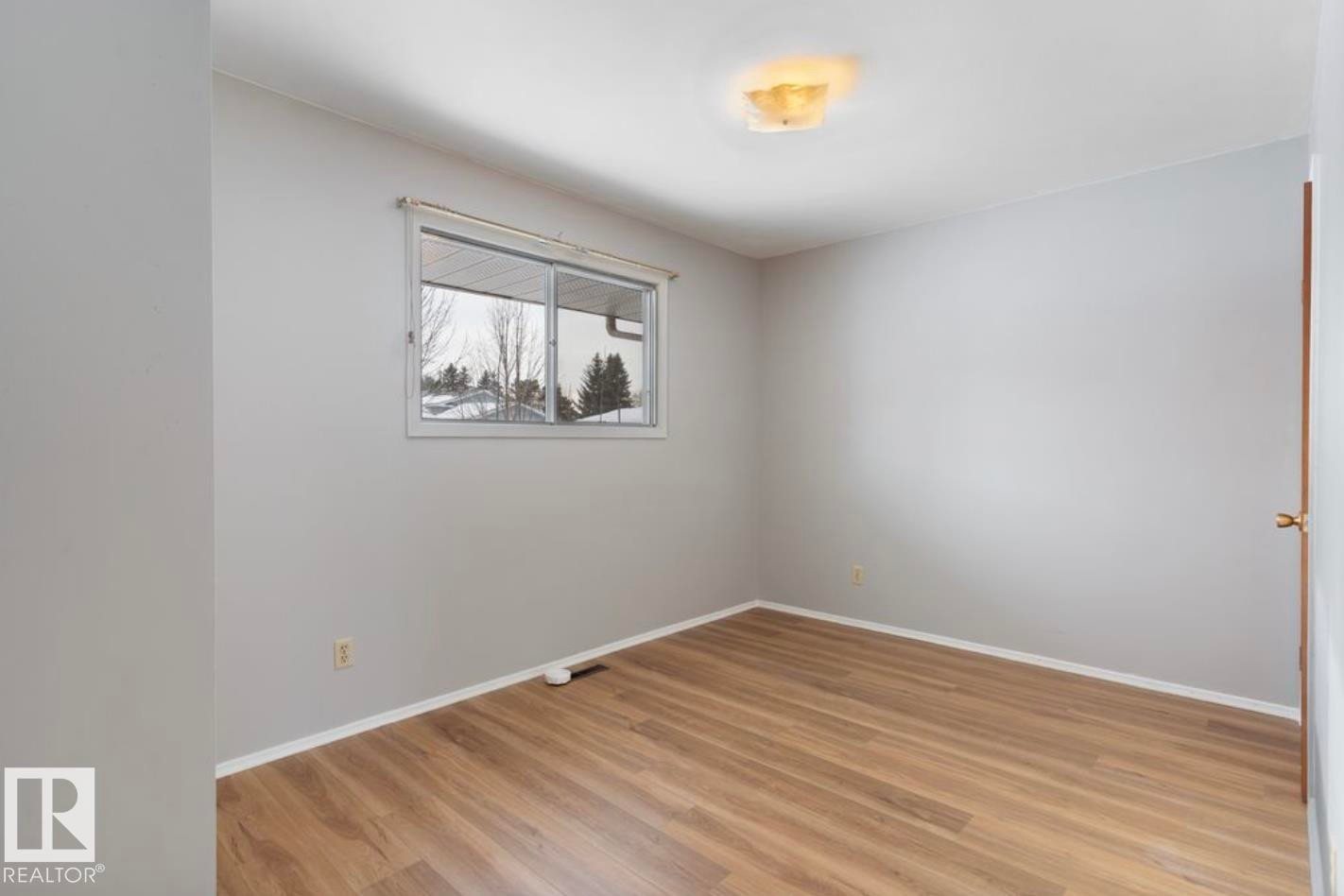 Spare room featuring baseboards and light wood finished floors - 3810 110 Avenue, Edmonton, AB - Indoor Photo Showing Other Room