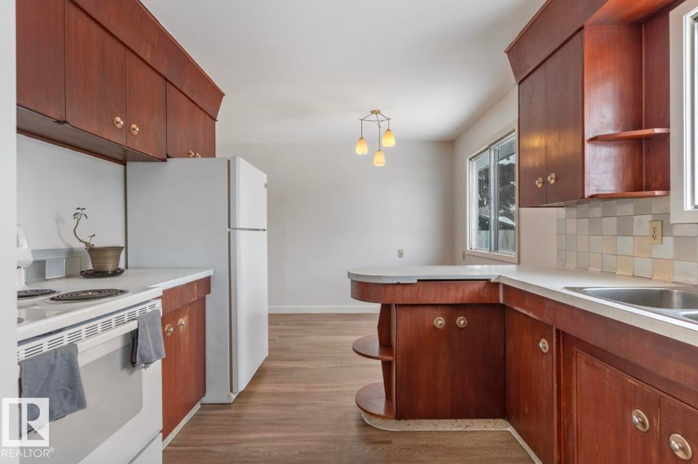 Kitchen featuring open shelves, white appliances, light countertops, and a peninsula - 3810 110 Avenue, Edmonton, AB - Indoor Photo Showing Kitchen