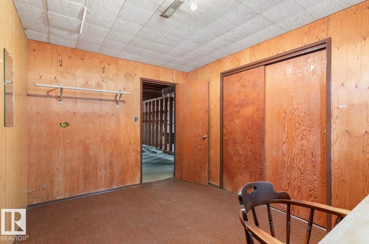 Bedroom featuring wooden walls, carpet, and a closet - 3810 110 Avenue, Edmonton, AB - Indoor Photo Showing Other Room